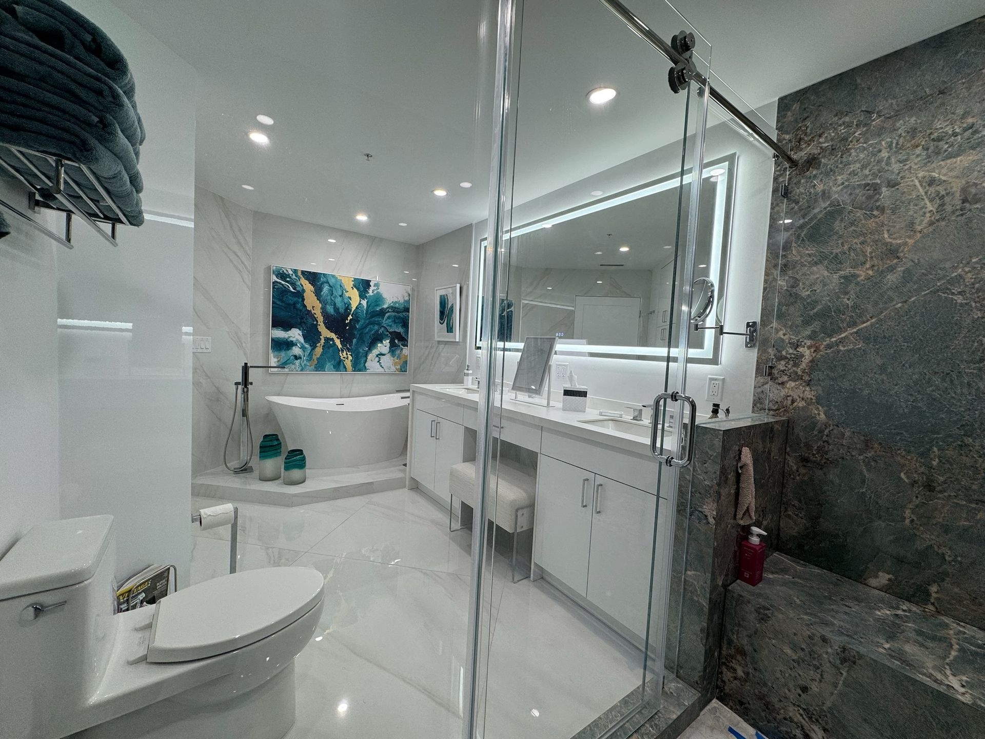 A bathroom with a toilet , sink , tub and shower.