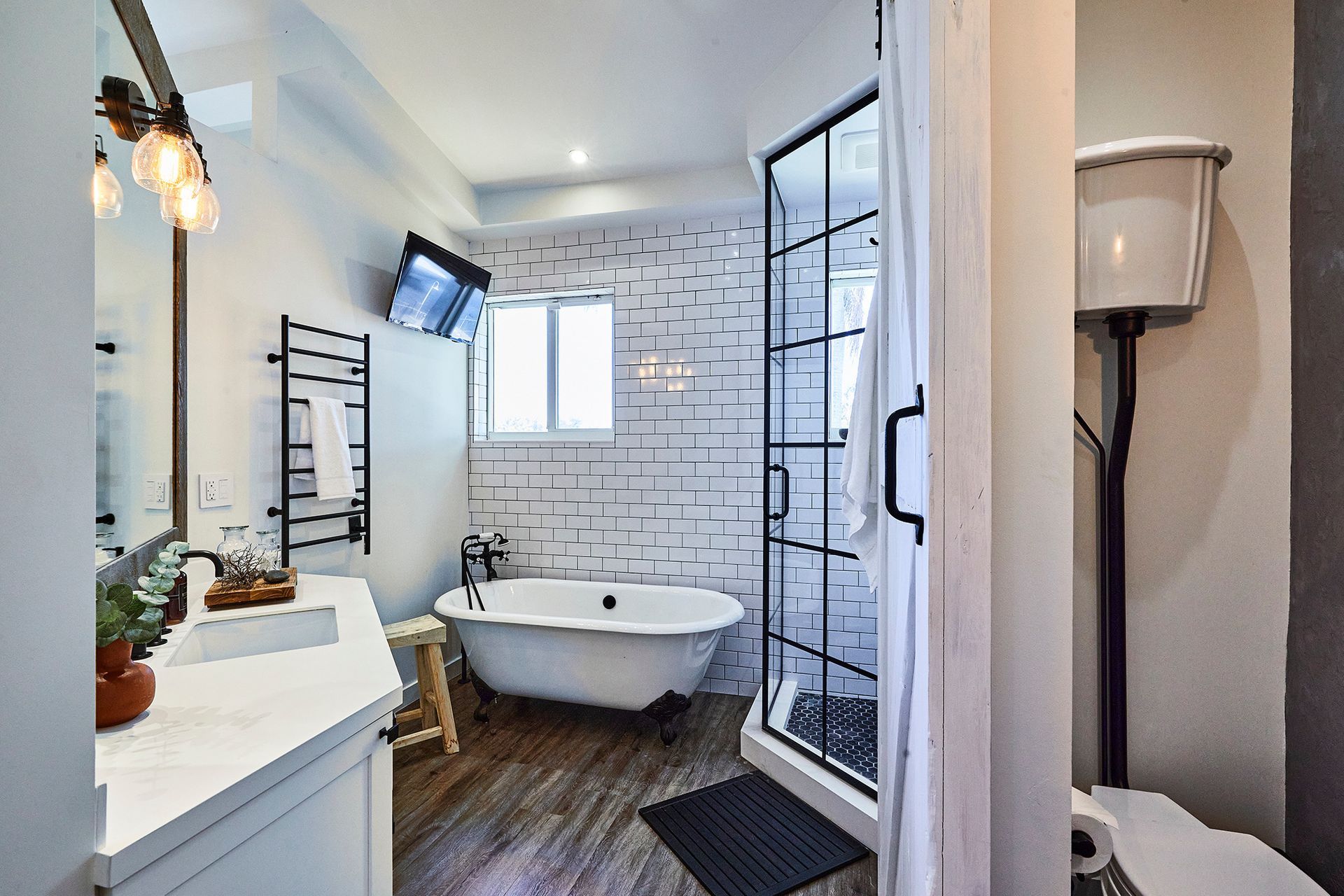 A bathroom with a tub , sink , toilet and shower.