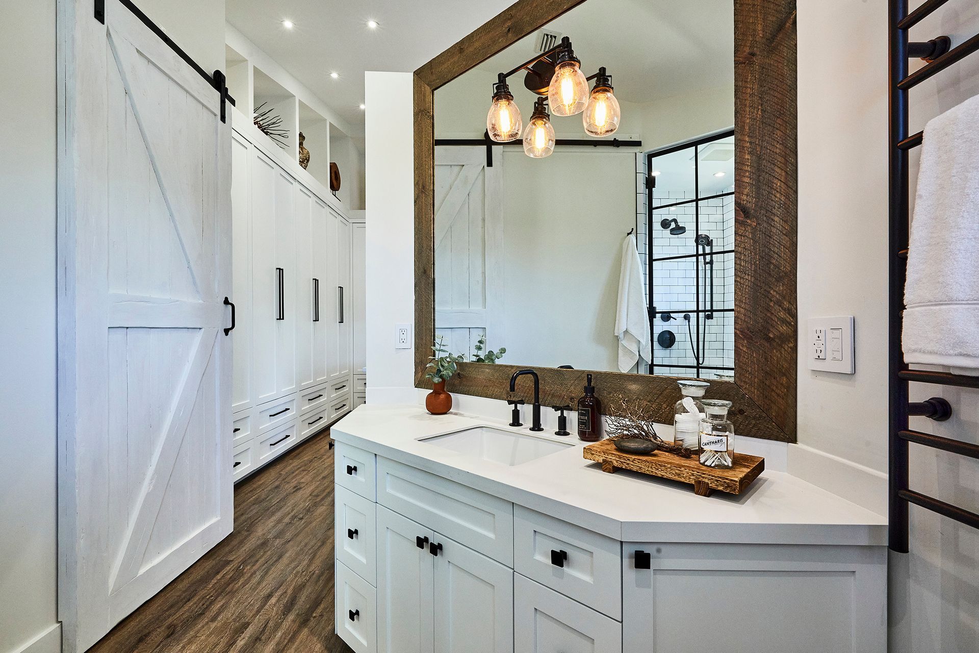 A bathroom with a large mirror and a sink.