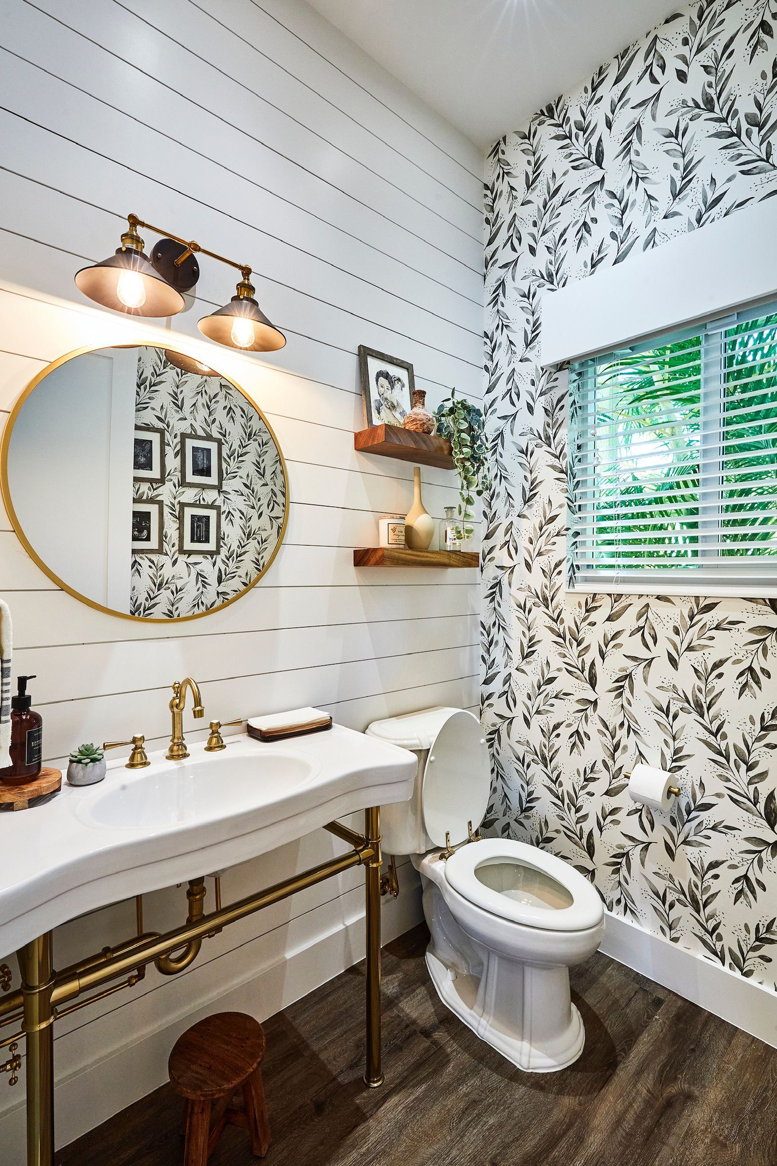 A bathroom with a sink , toilet and mirror.