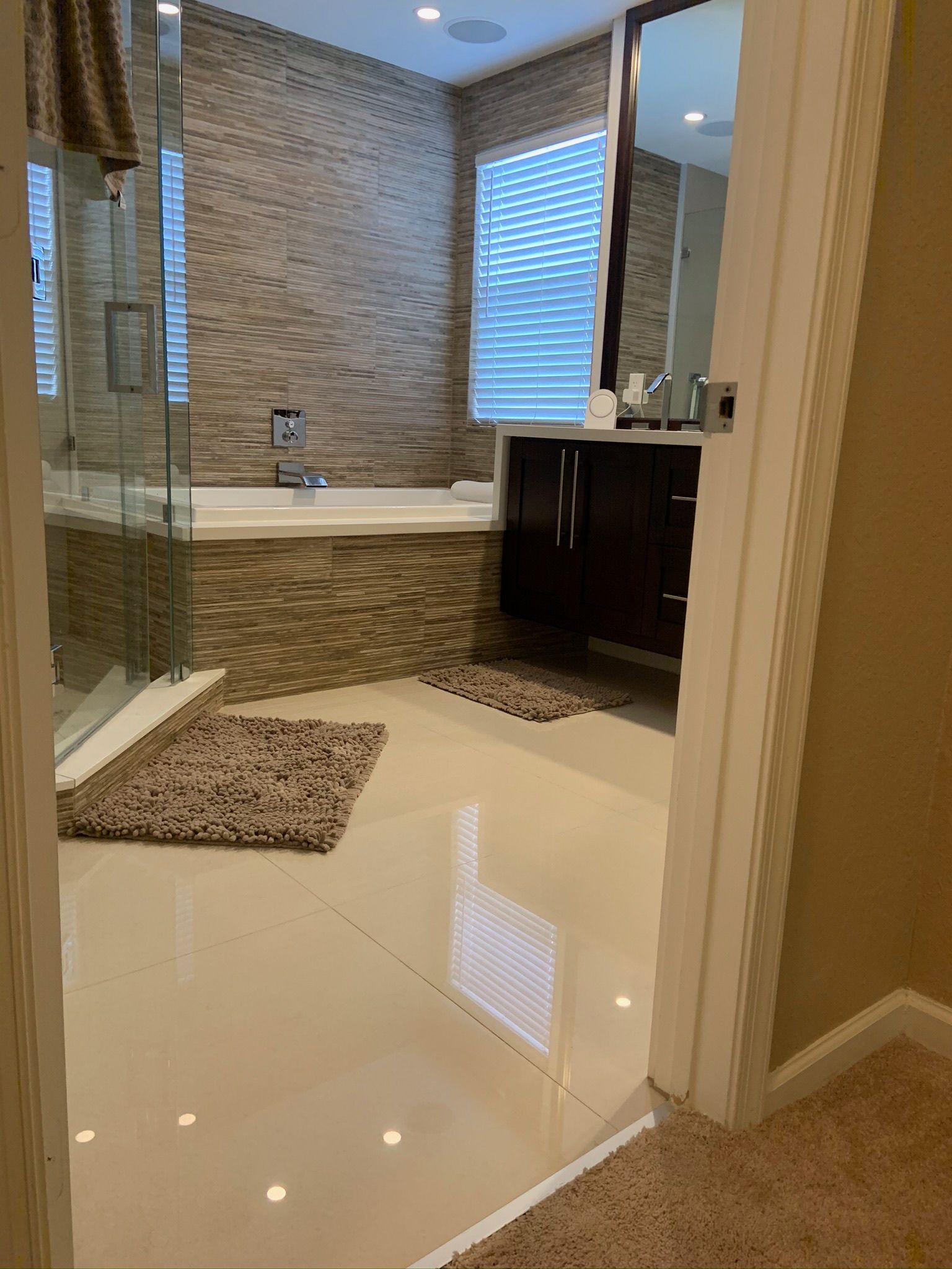 A bathroom with a tub , sink , mirror and walk in shower.