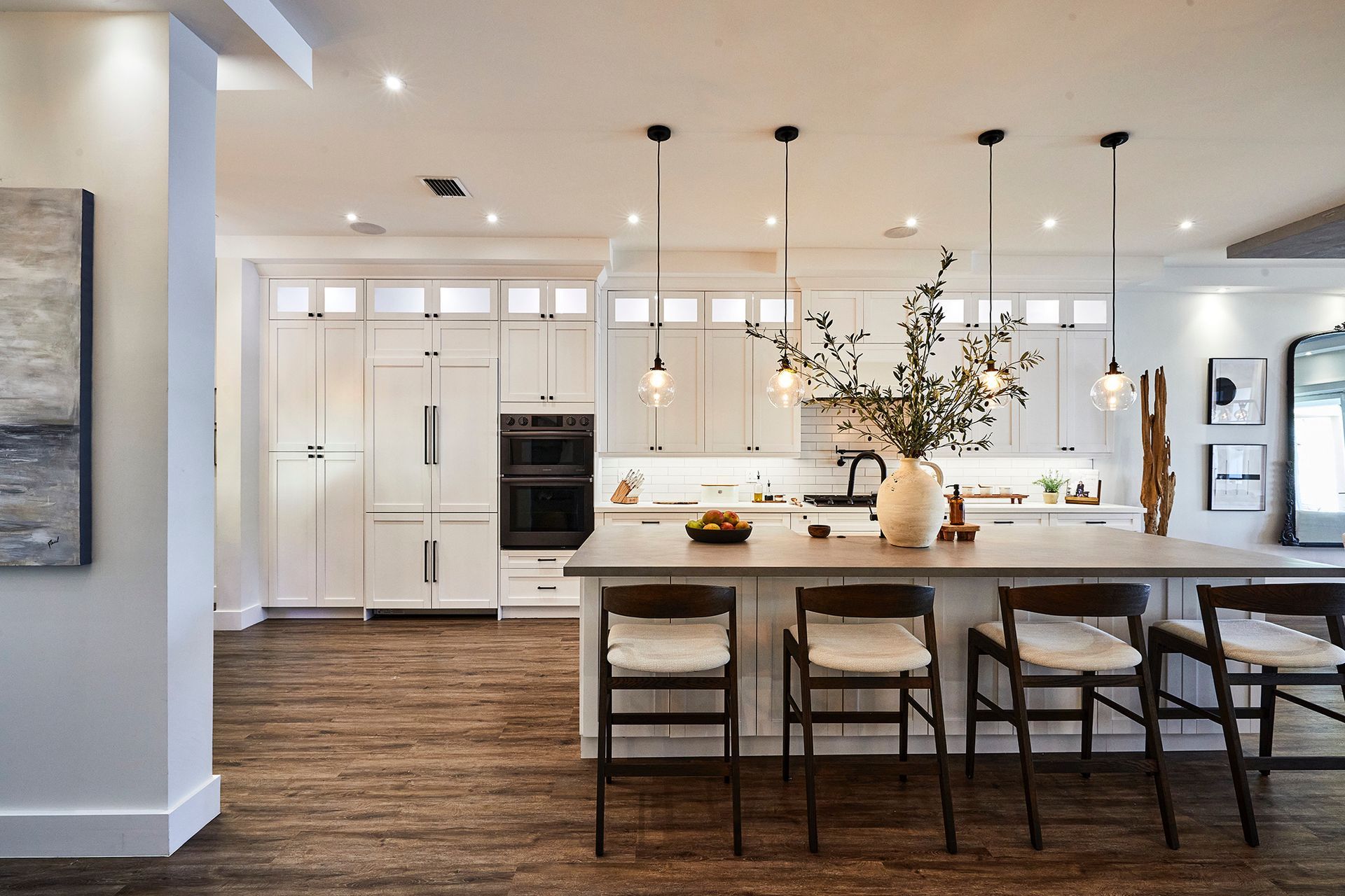 A kitchen with white cabinets and a large island