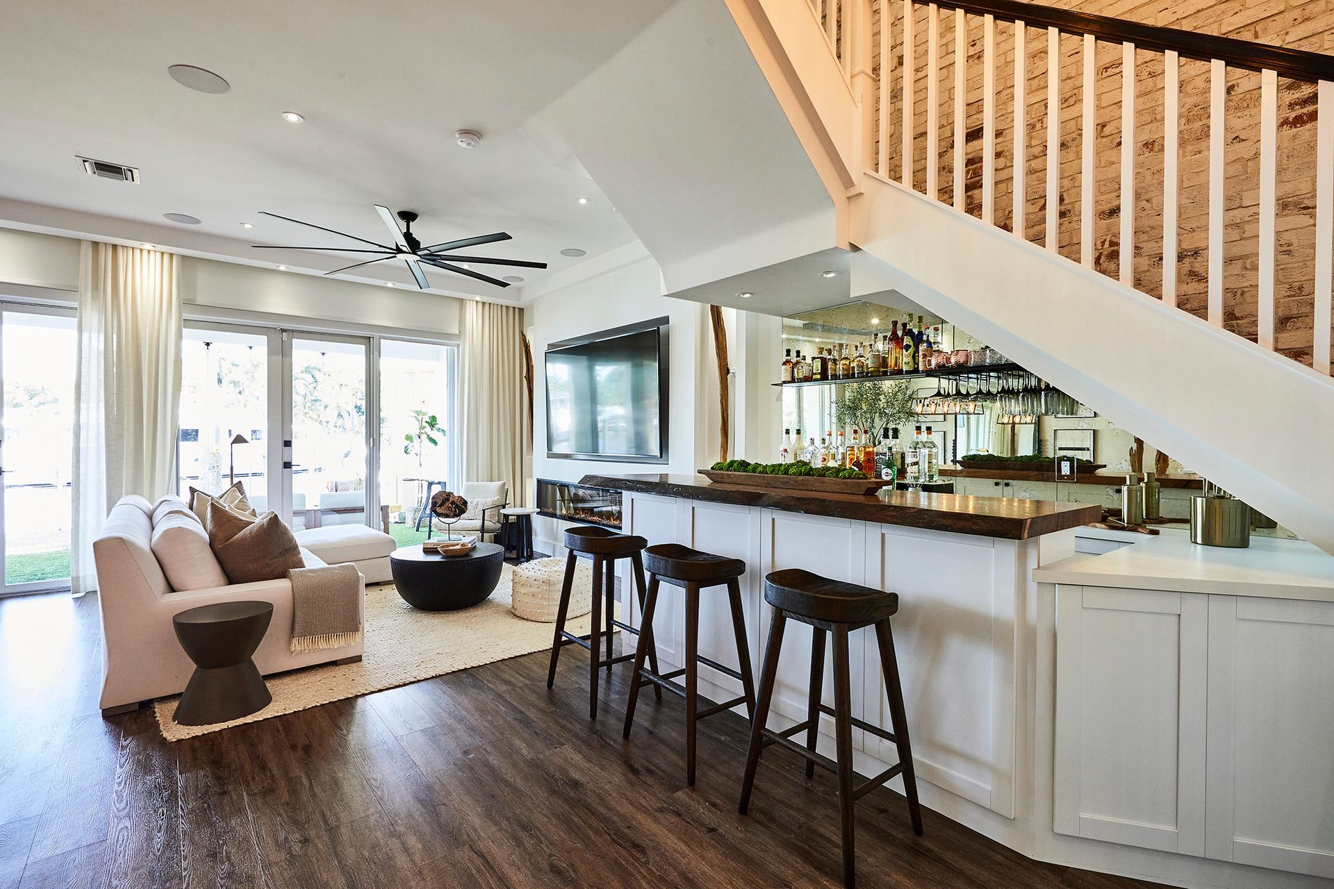 There is a bar under the stairs in the living room.