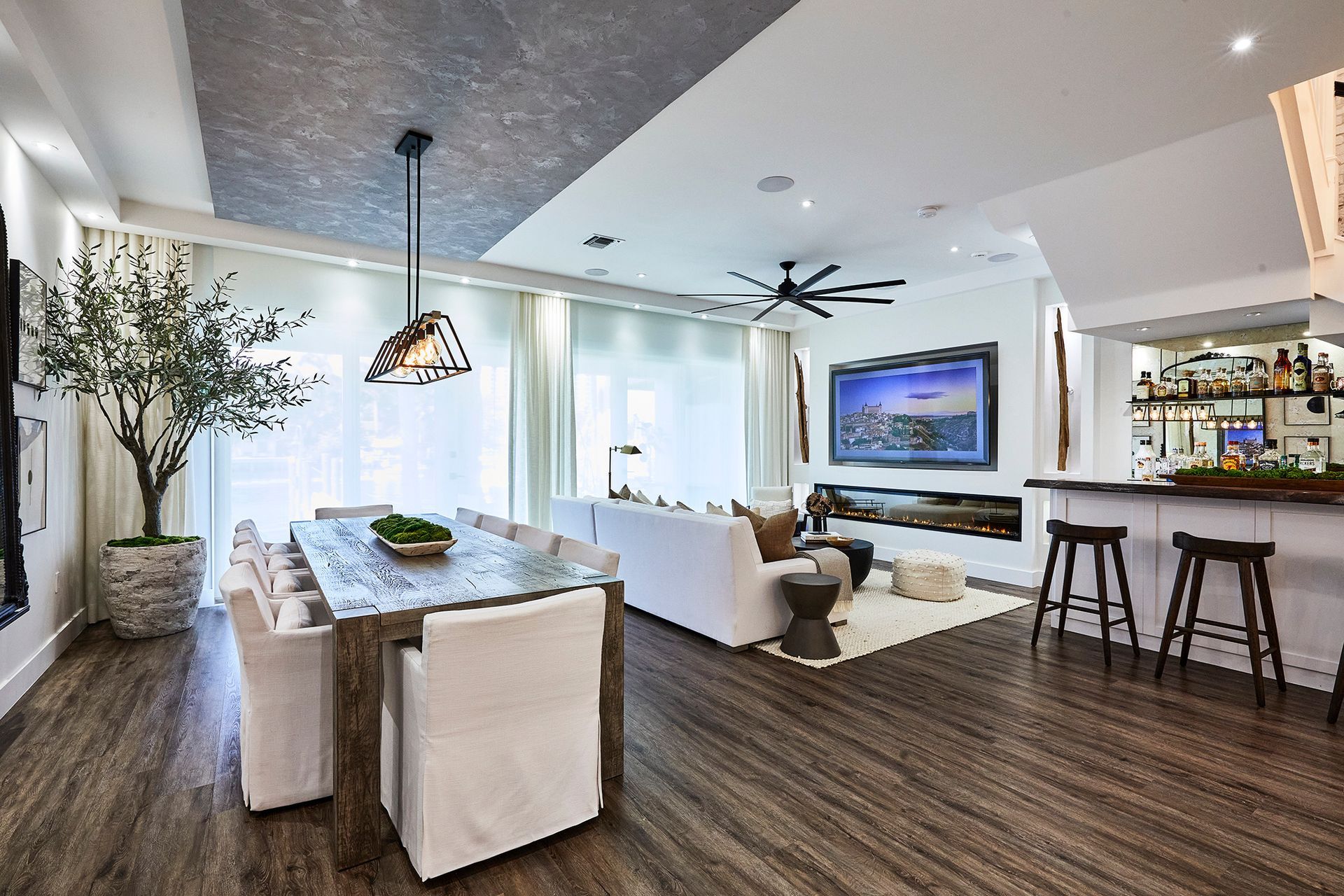 A living room with a couch , table , chairs and a television.