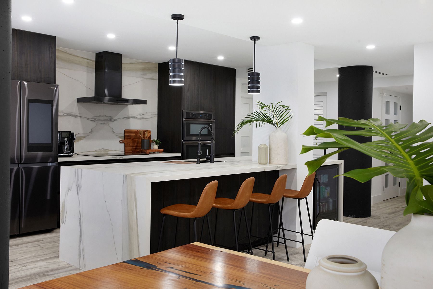 A kitchen with a table and chairs and a large island.