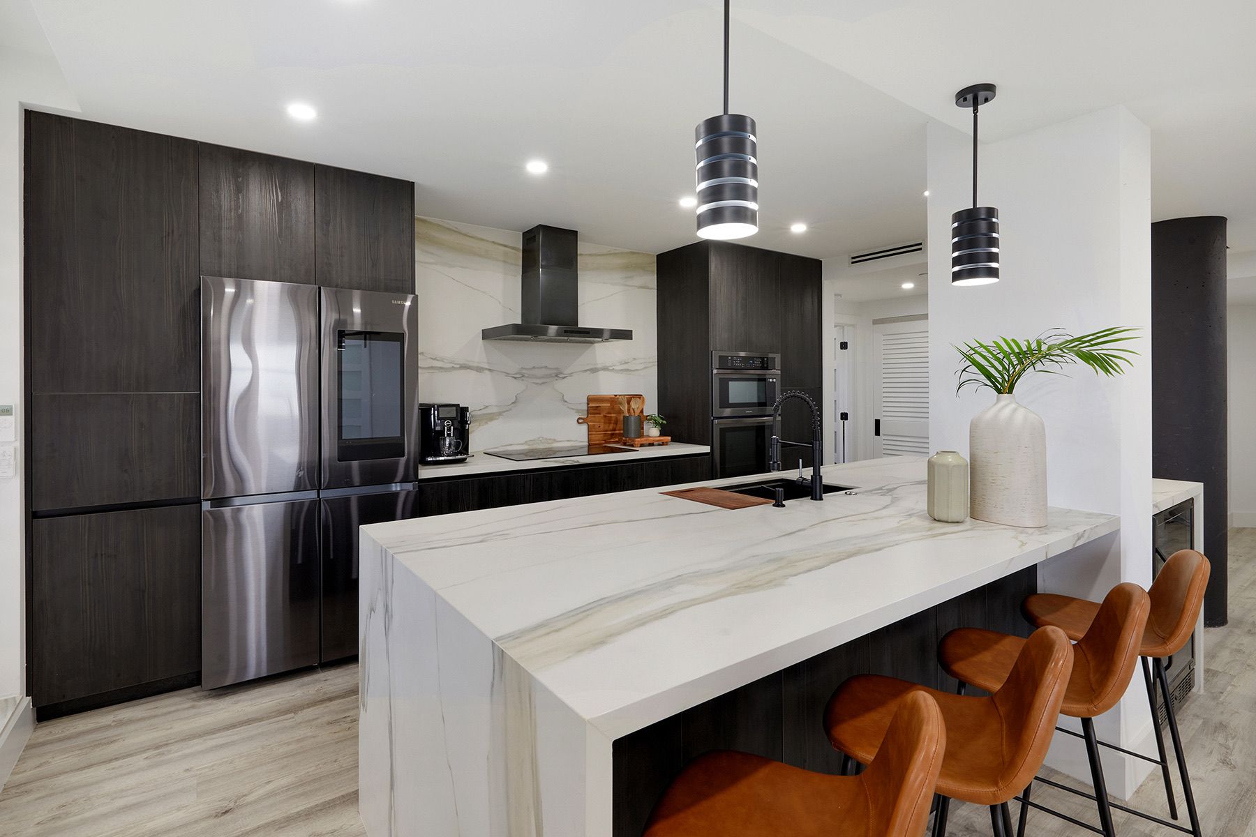 A kitchen with stainless steel appliances and a large island.