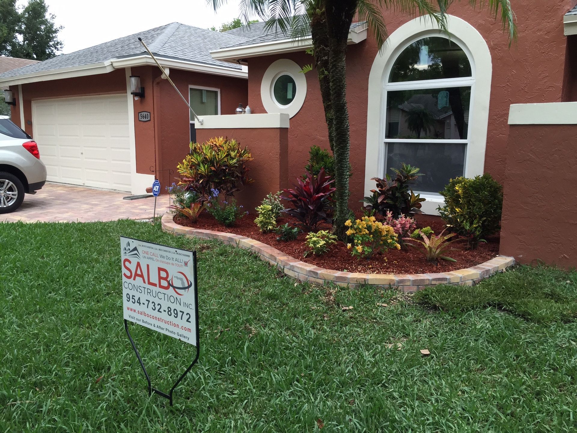A house with a for sale sign in front of it