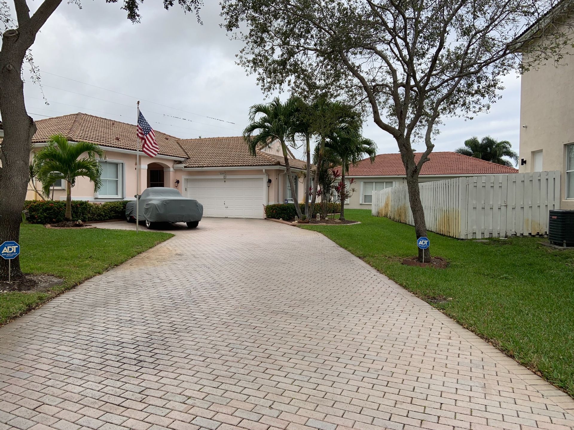 A car is parked in the driveway of a house
