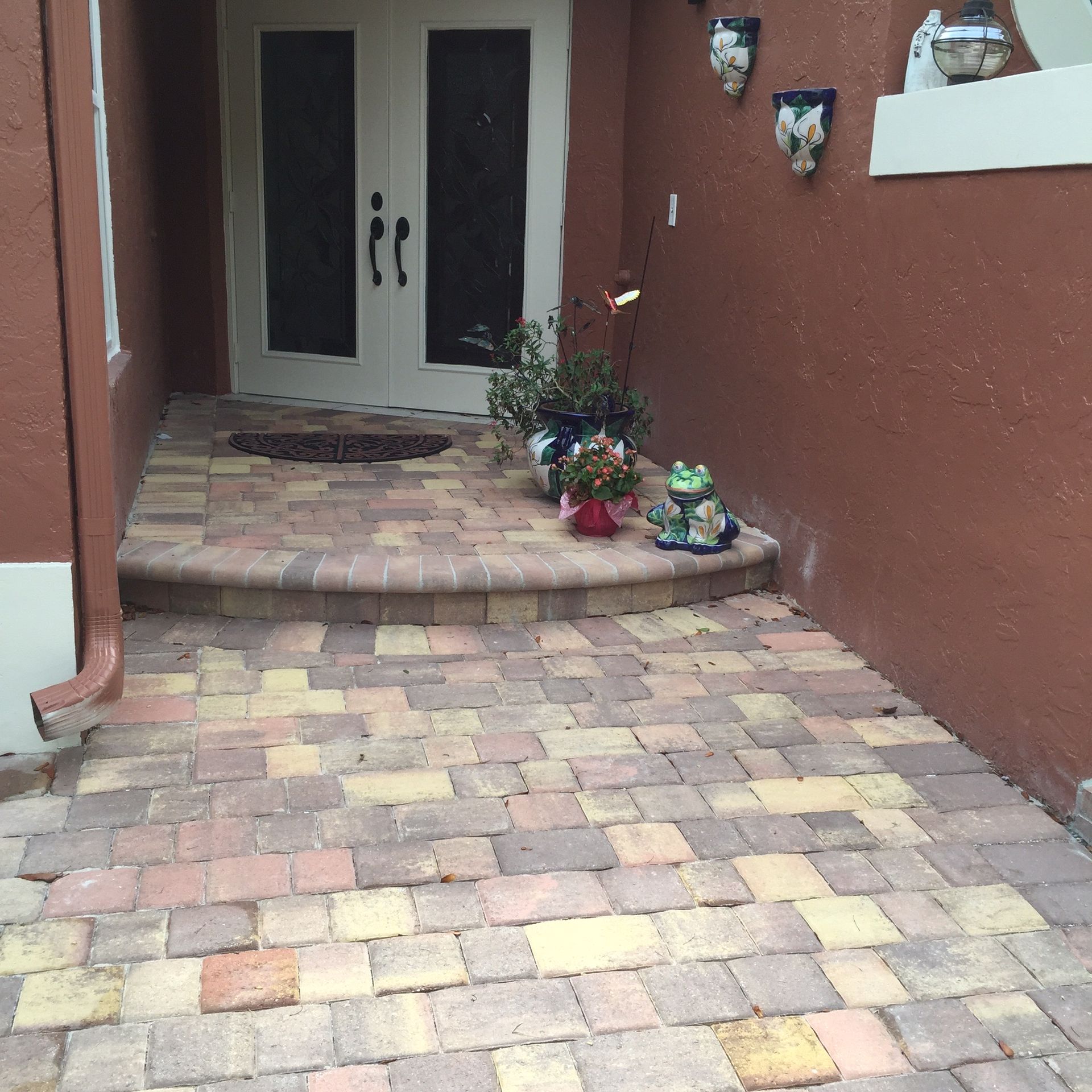 A brick walkway leading to the front door of a house