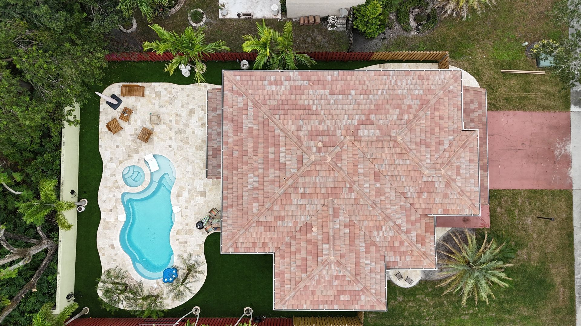 An aerial view of a house with a pool in the backyard.