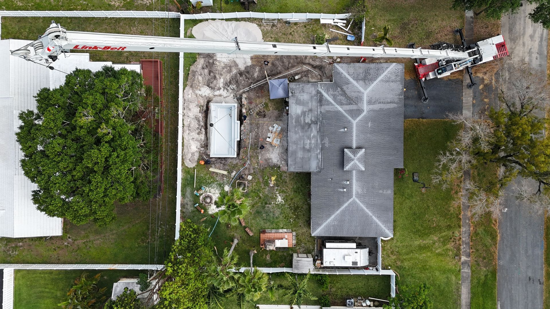 An aerial view of a house with a crane on the roof.