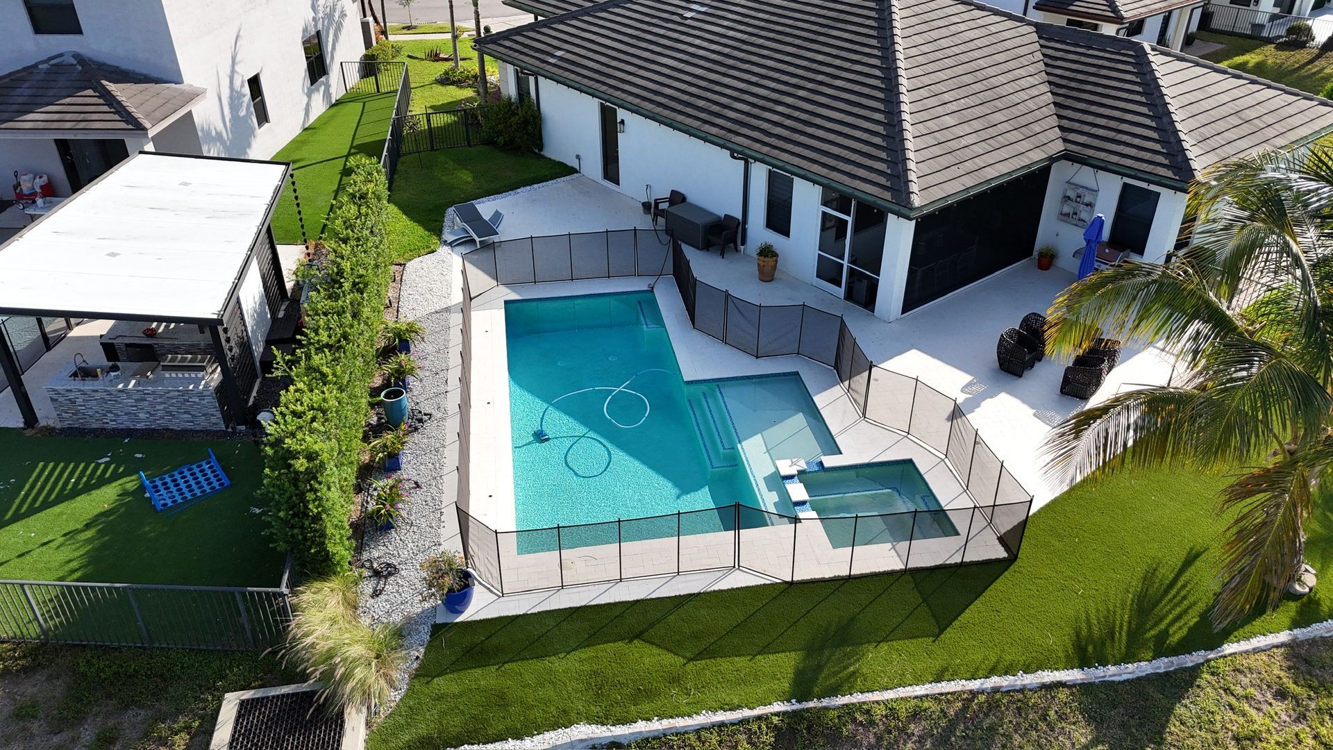 An aerial view of a house with a large swimming pool