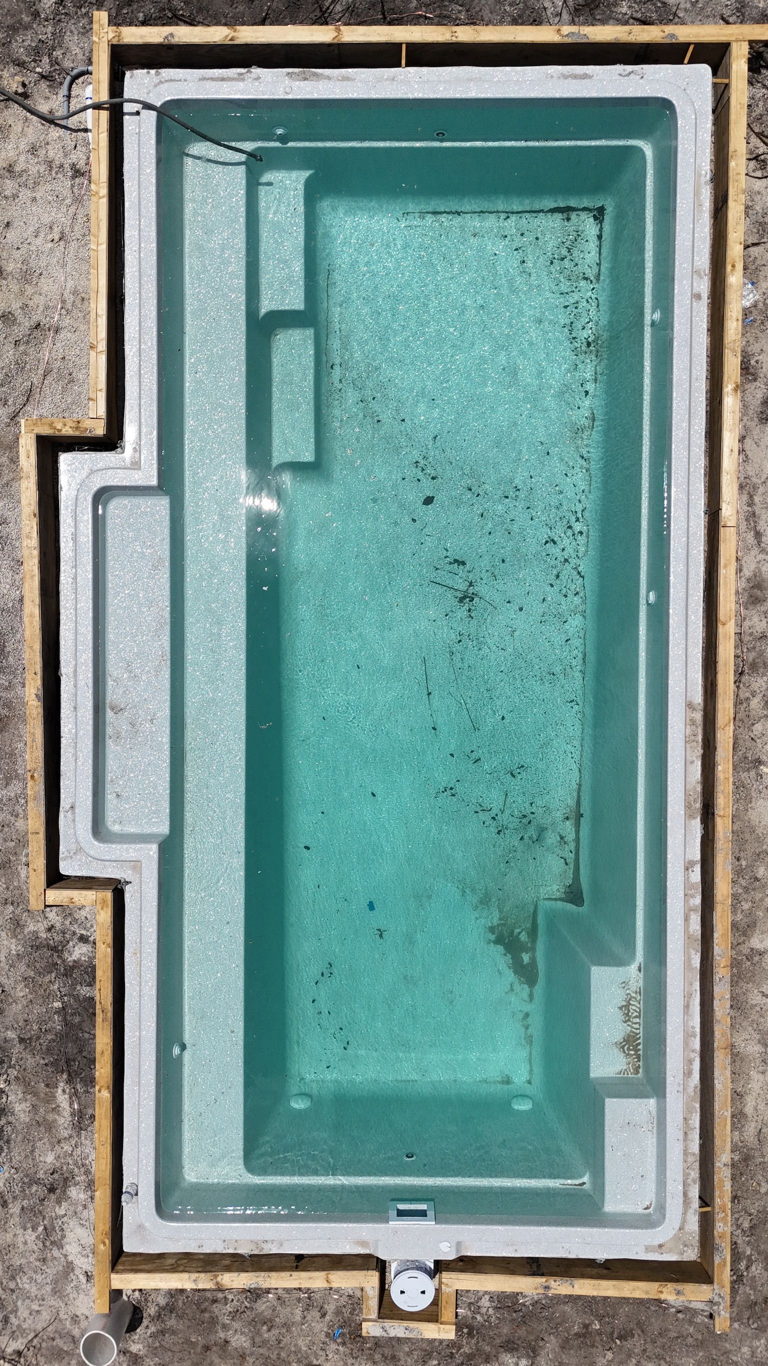 An aerial view of a swimming pool under construction.