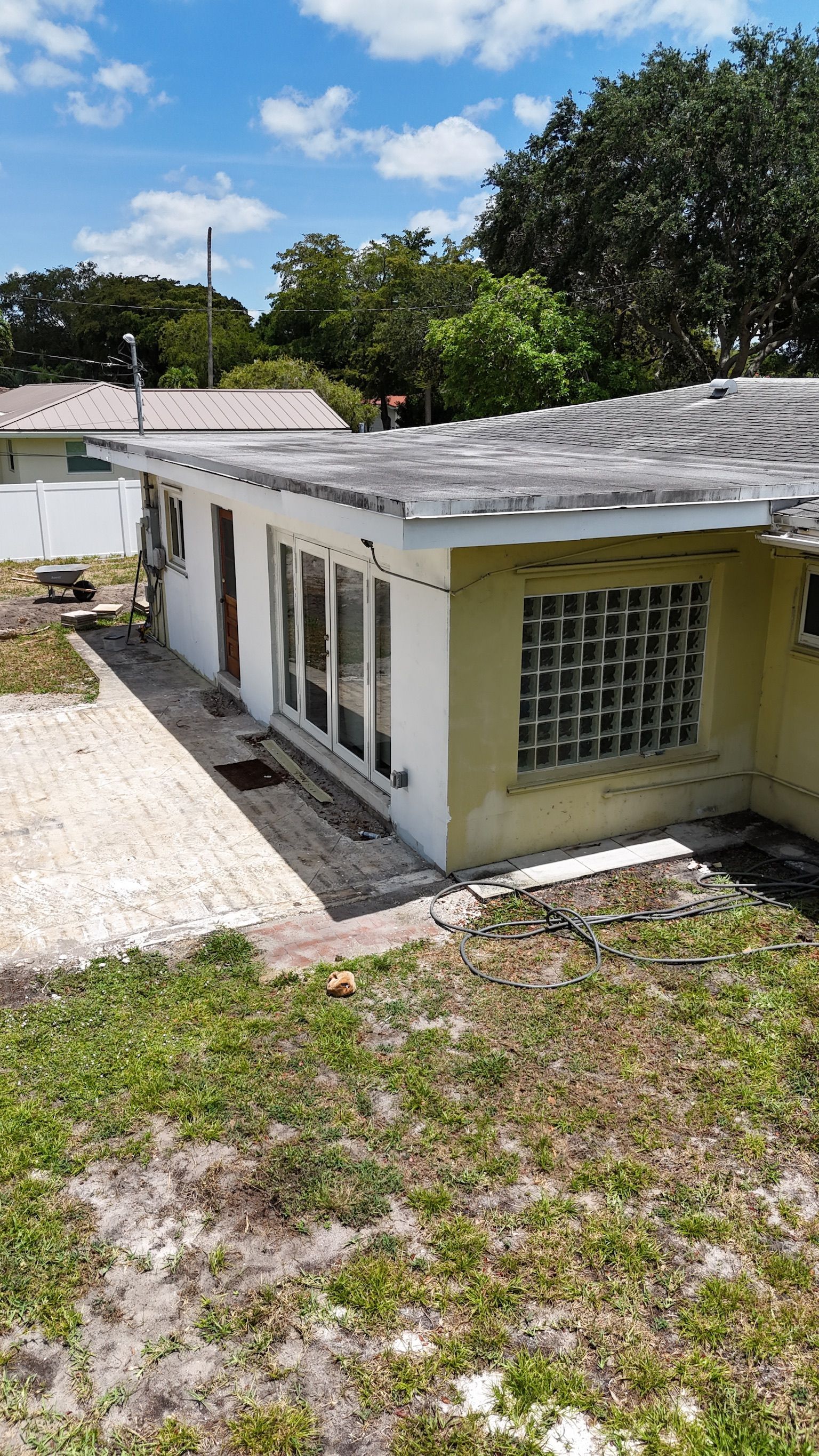 An aerial view of a house with a roof that is covered in shingles.