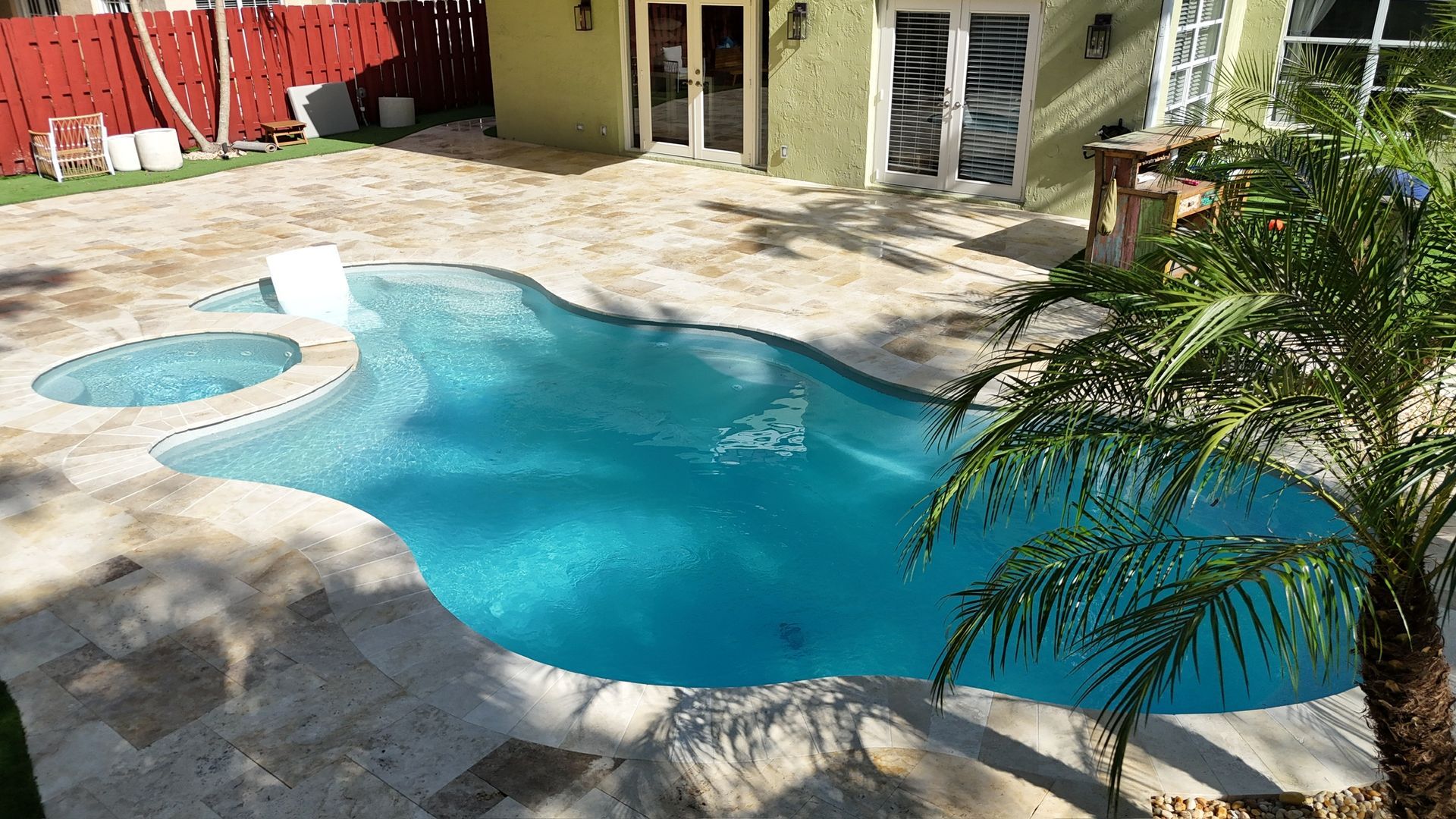 A large swimming pool in the backyard of a house