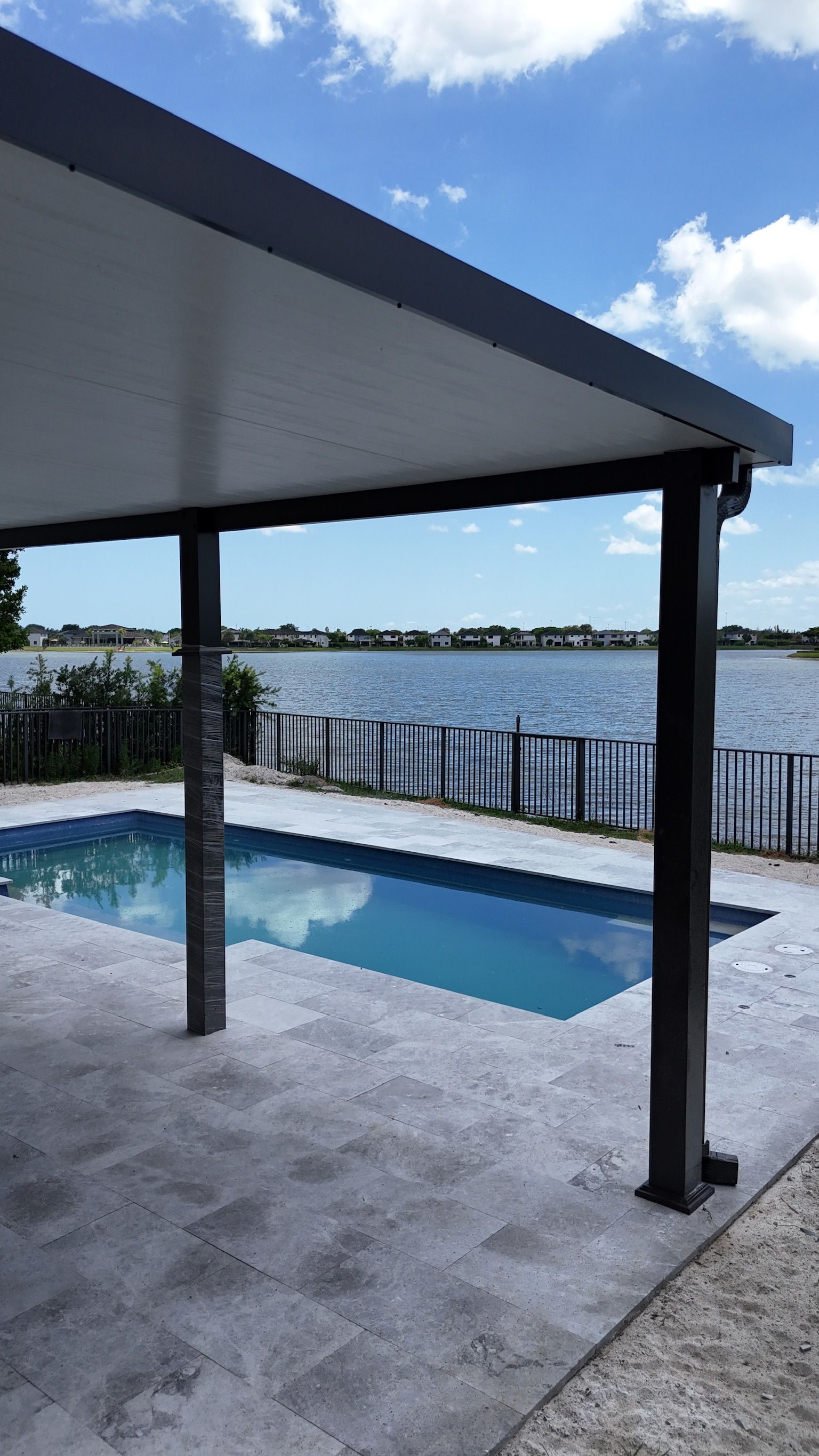 A large swimming pool is surrounded by a large body of water.