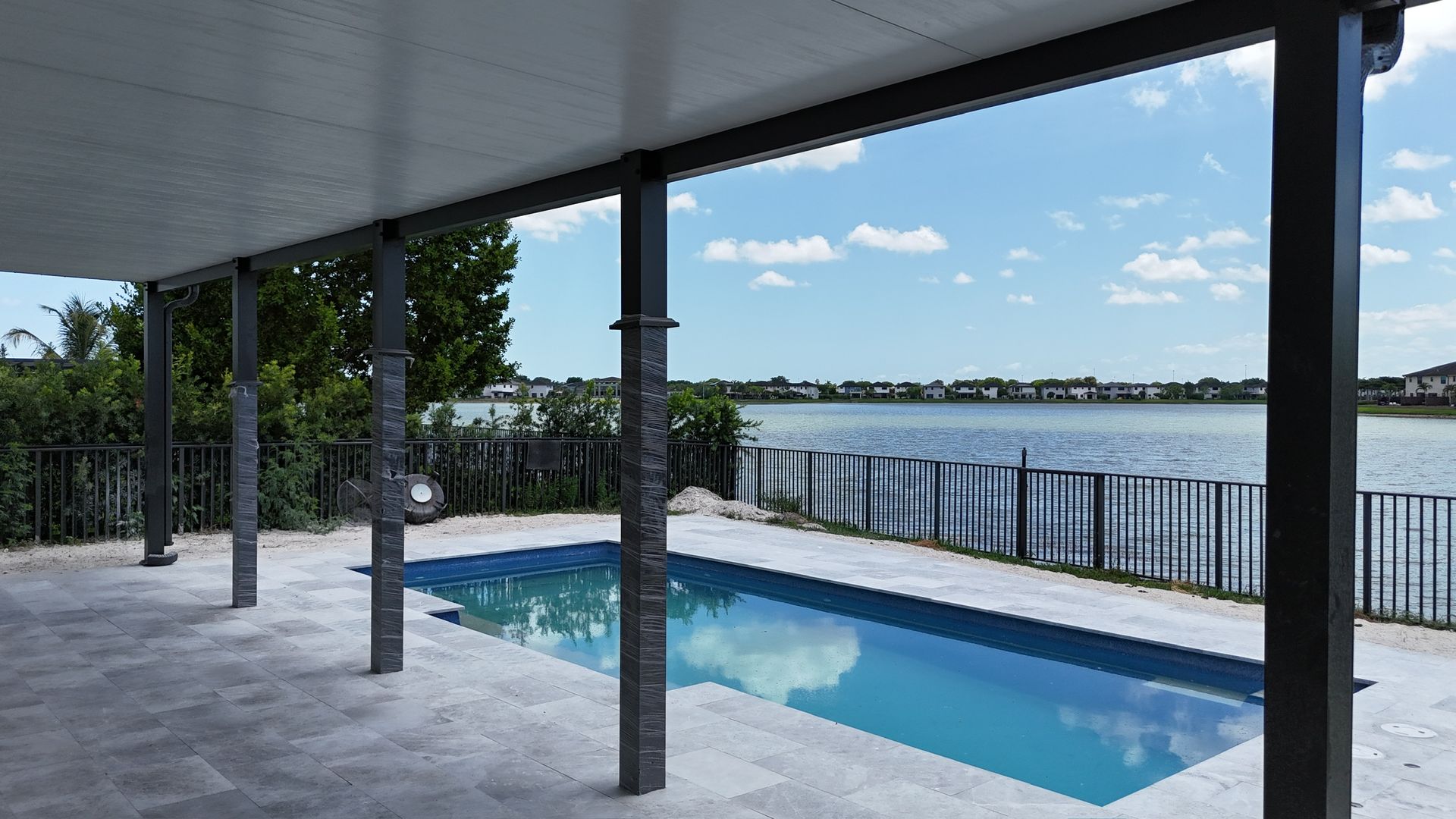 A large swimming pool is surrounded by a large body of water.