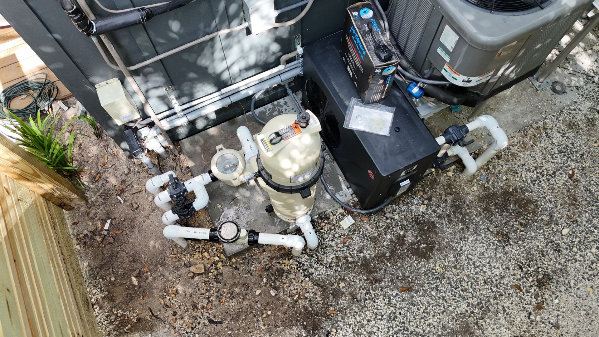 An aerial view of a swimming pool pump and air conditioner.