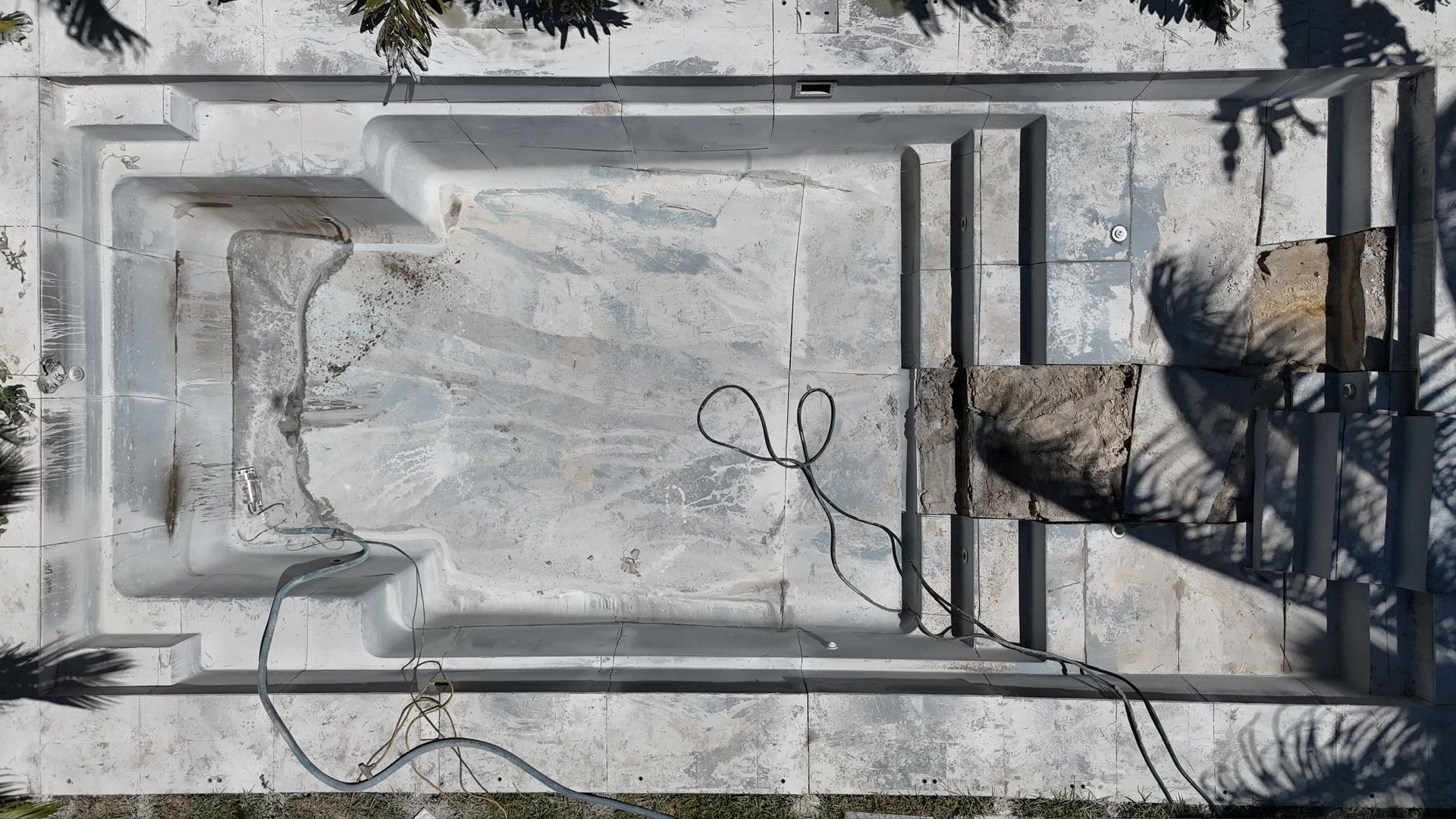 An aerial view of an empty swimming pool.
