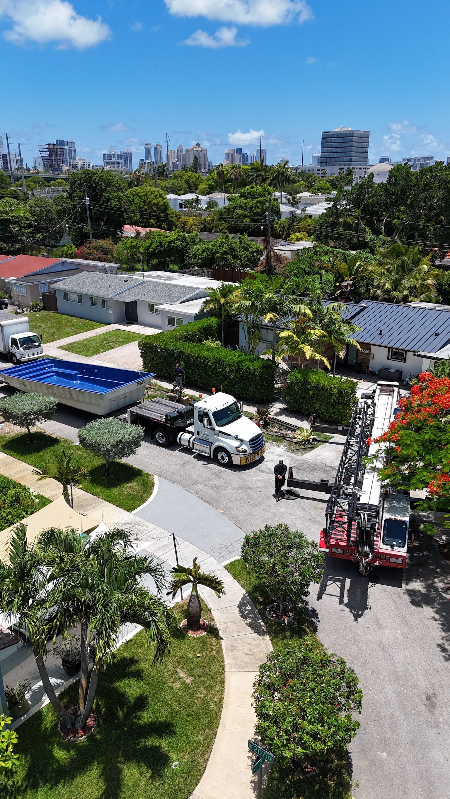 An aerial view of a residential area with a truck and a crane.