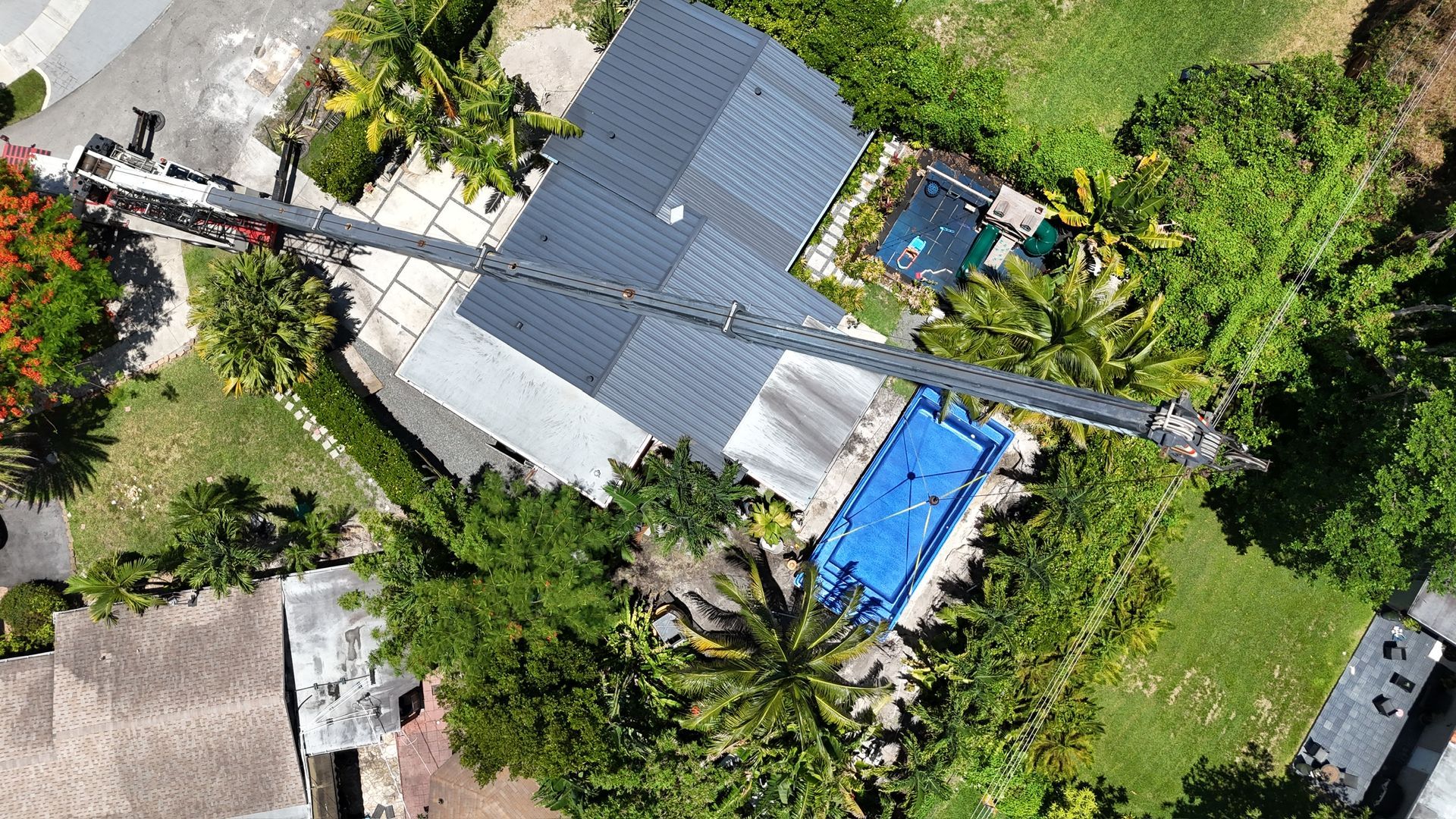 An aerial view of a house with a pool in the backyard.