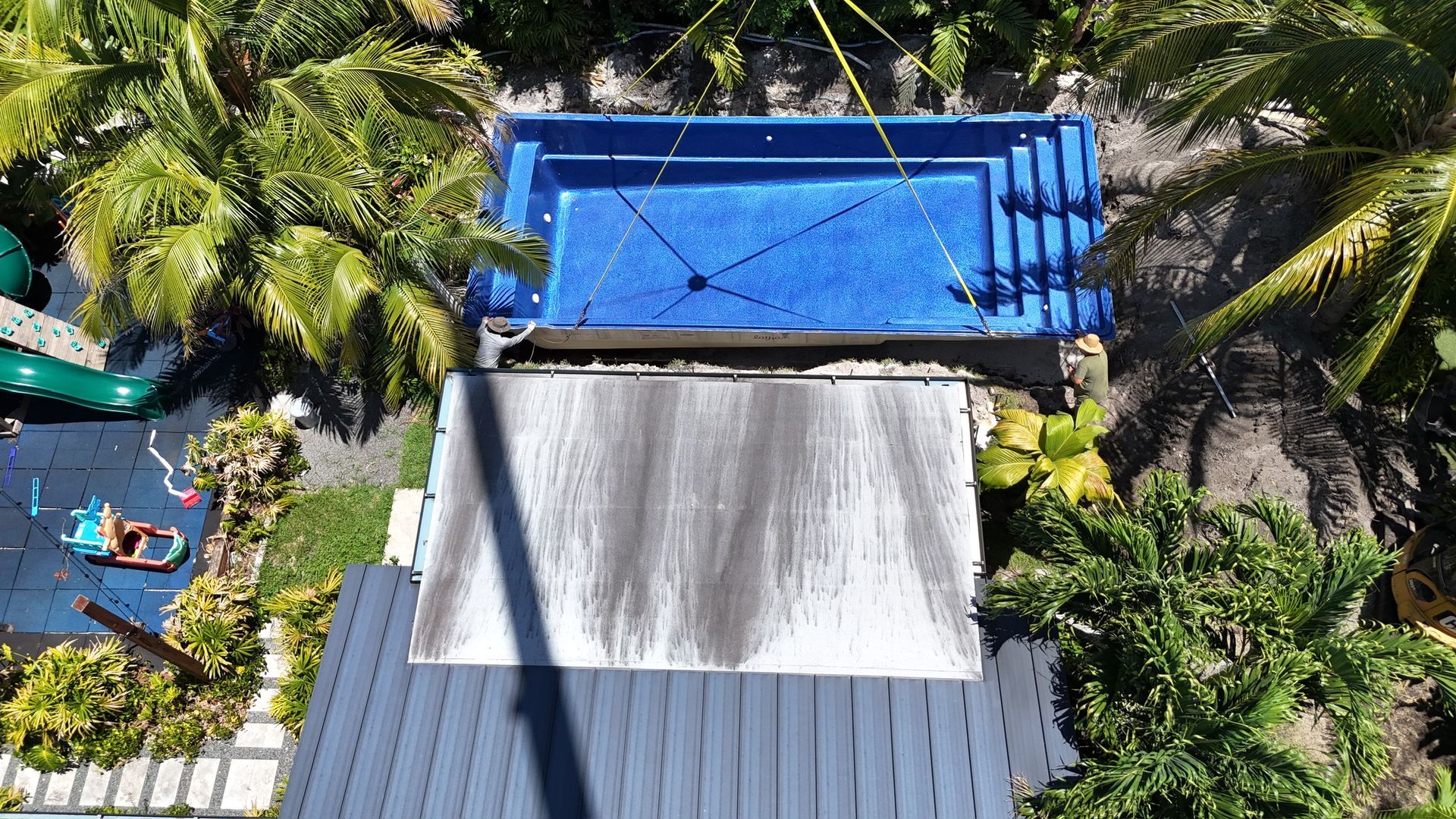 An aerial view of a house with a swimming pool and a slide.