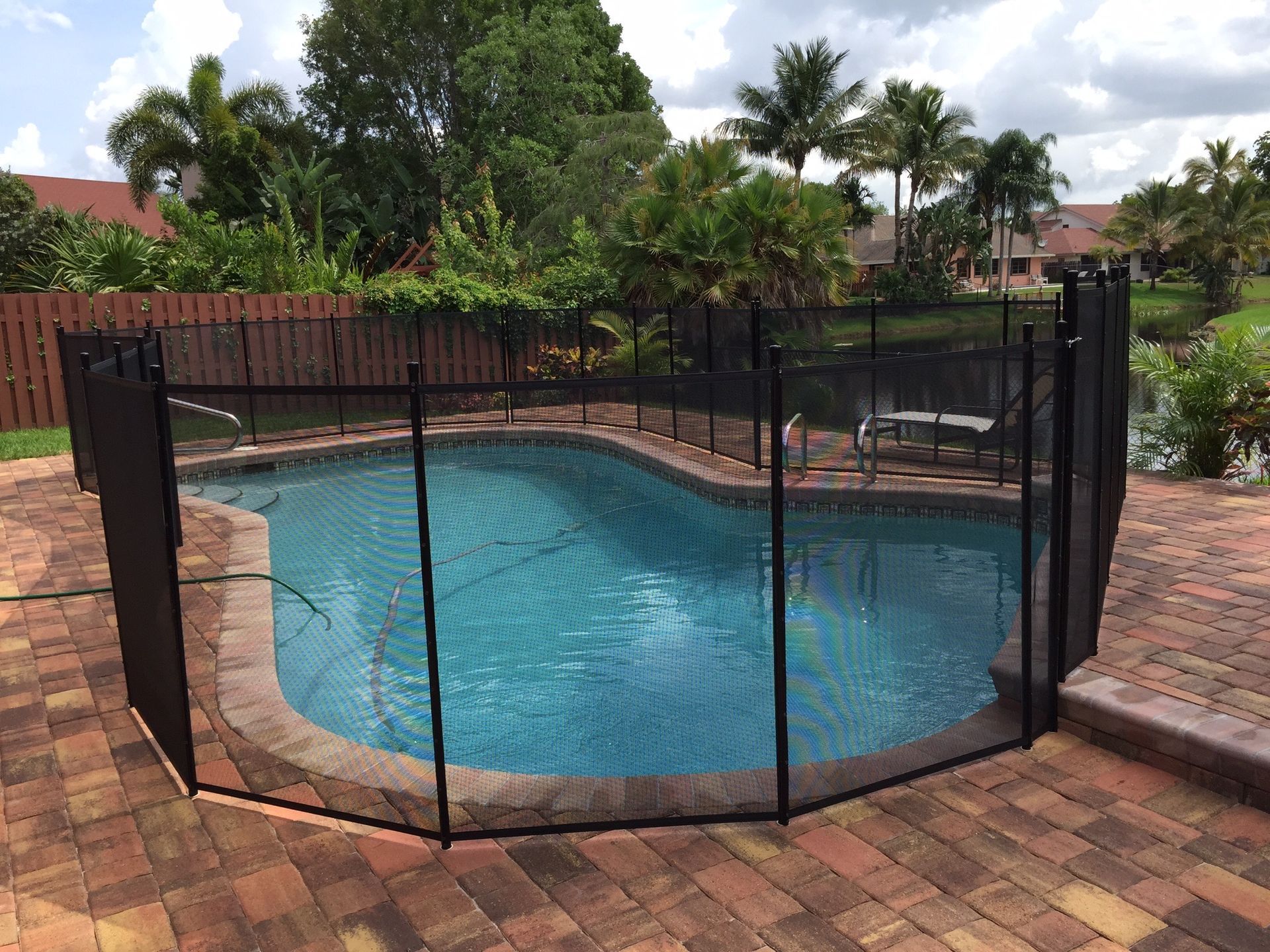 A large swimming pool with a fence around it.