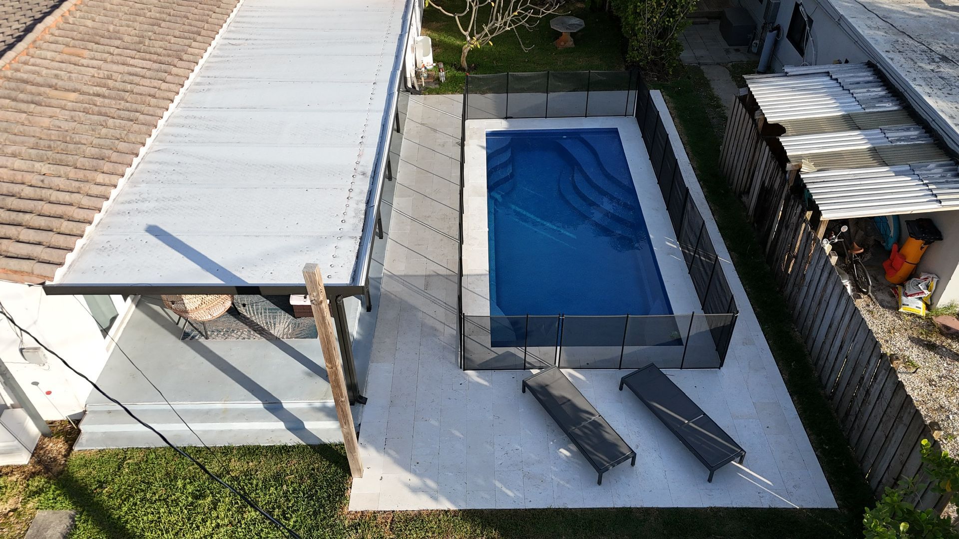 An aerial view of a swimming pool in a backyard