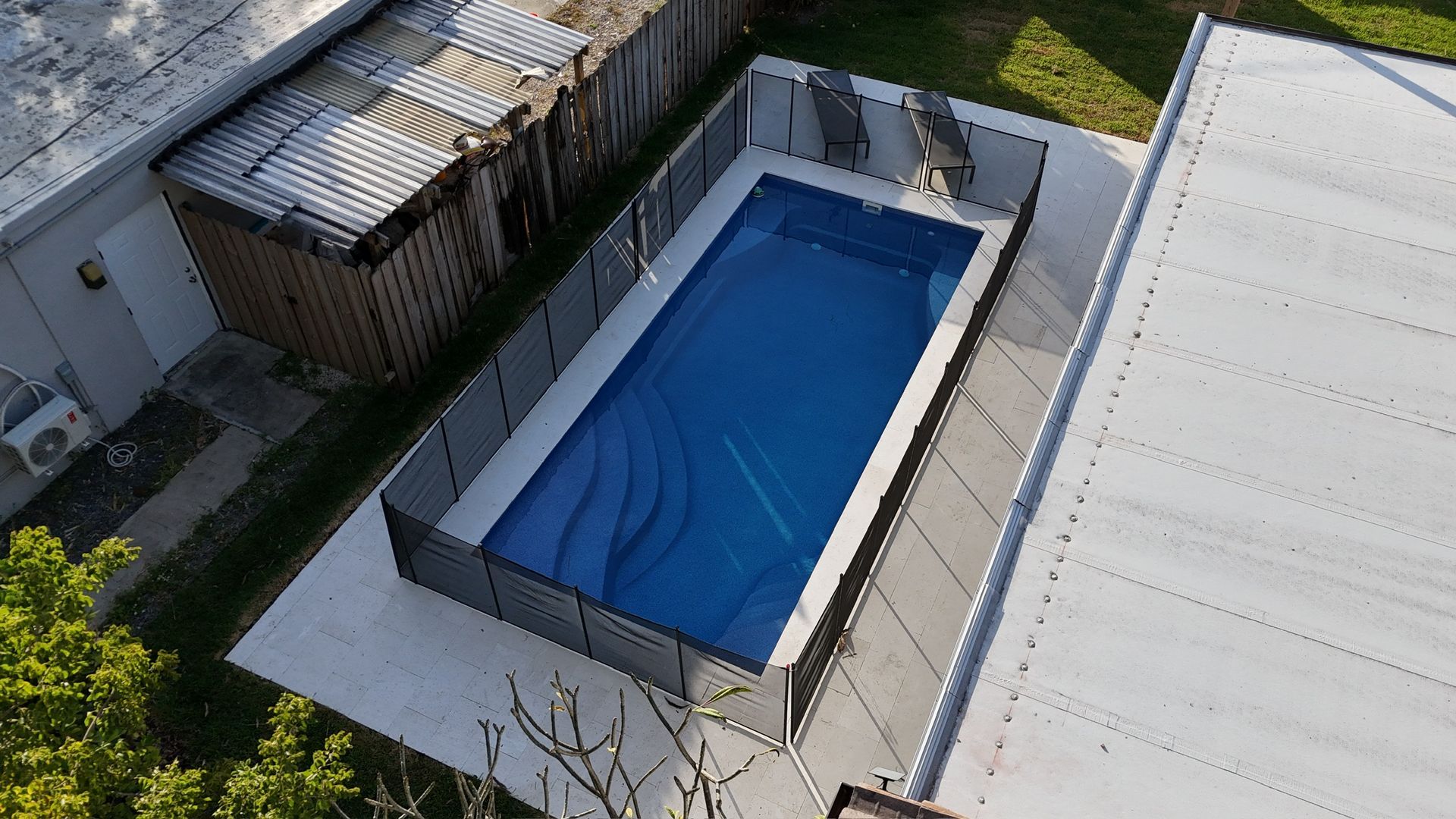 An aerial view of a swimming pool in a backyard