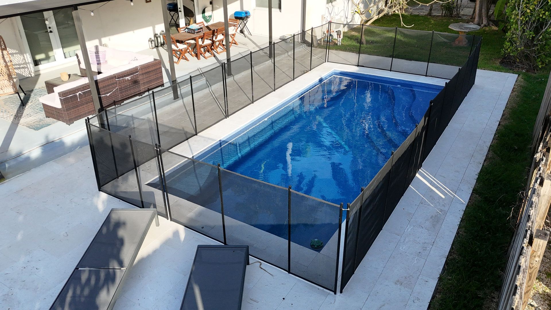 A large swimming pool with a black fence around it