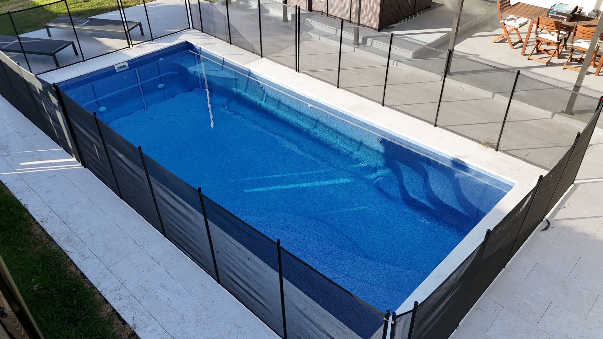 A large swimming pool with a fence around it