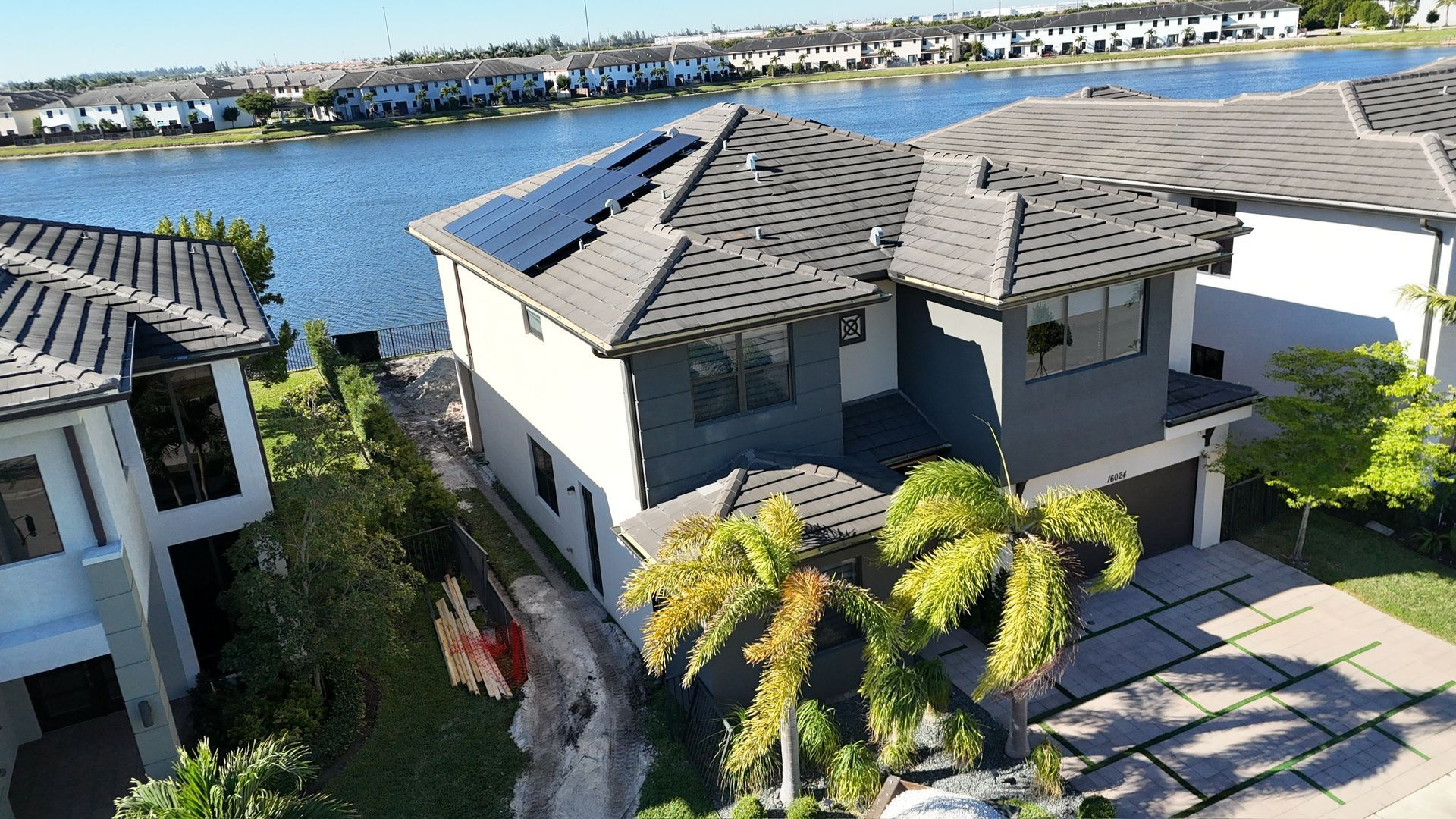 An aerial view of a house with solar panels on the roof