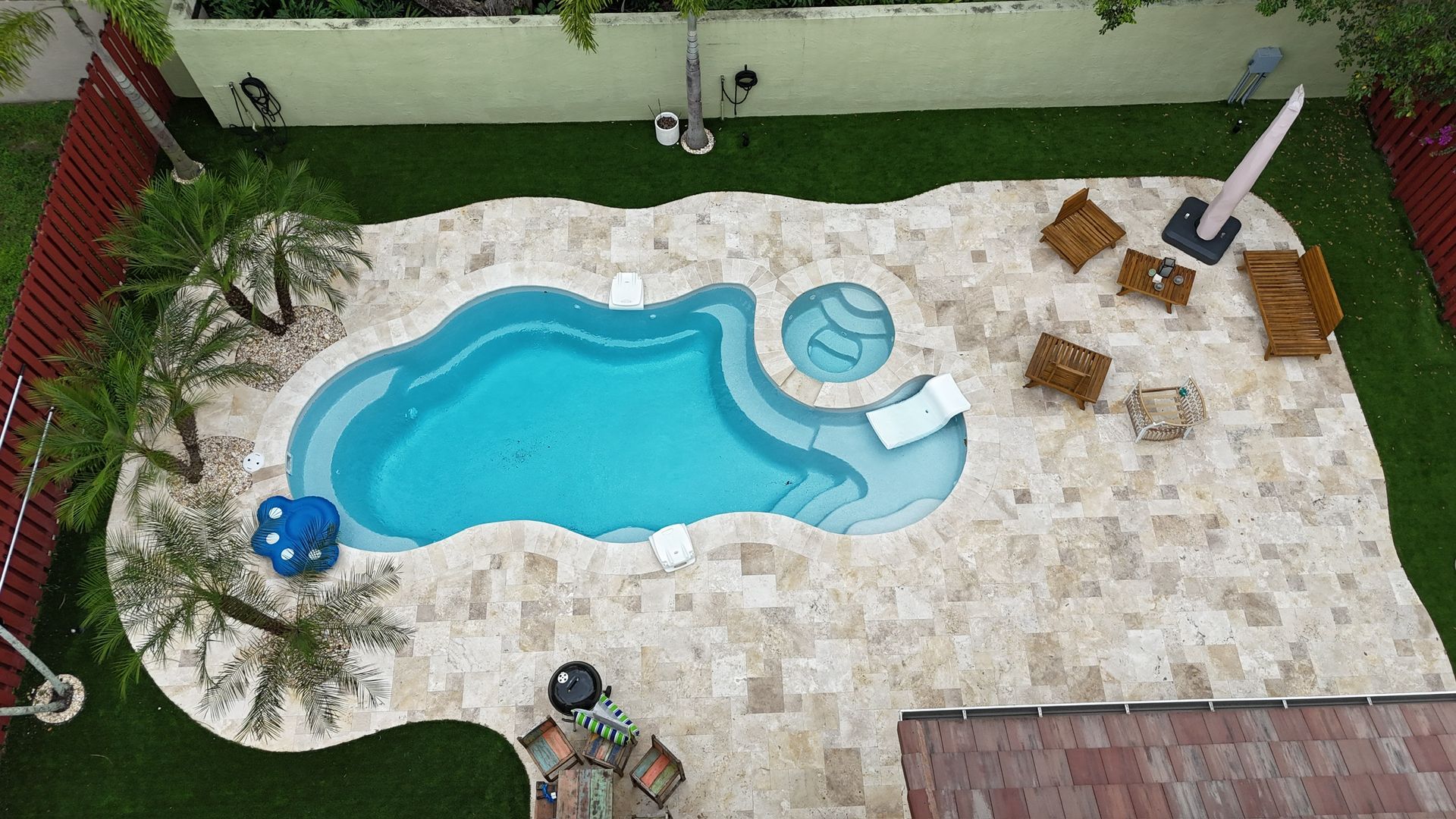 An aerial view of a large swimming pool in a backyard.