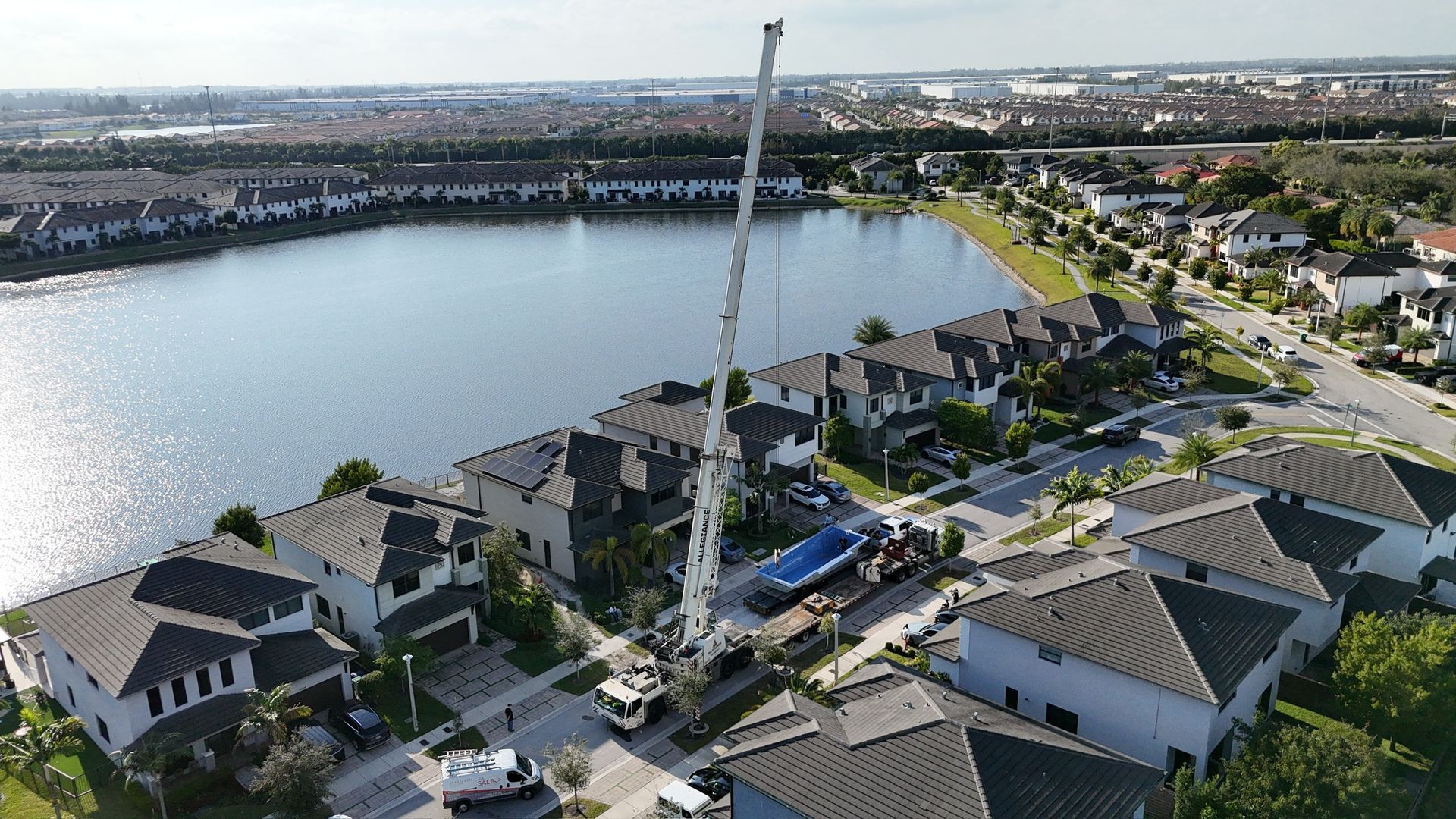 An aerial view of a residential area with a lake in the background.