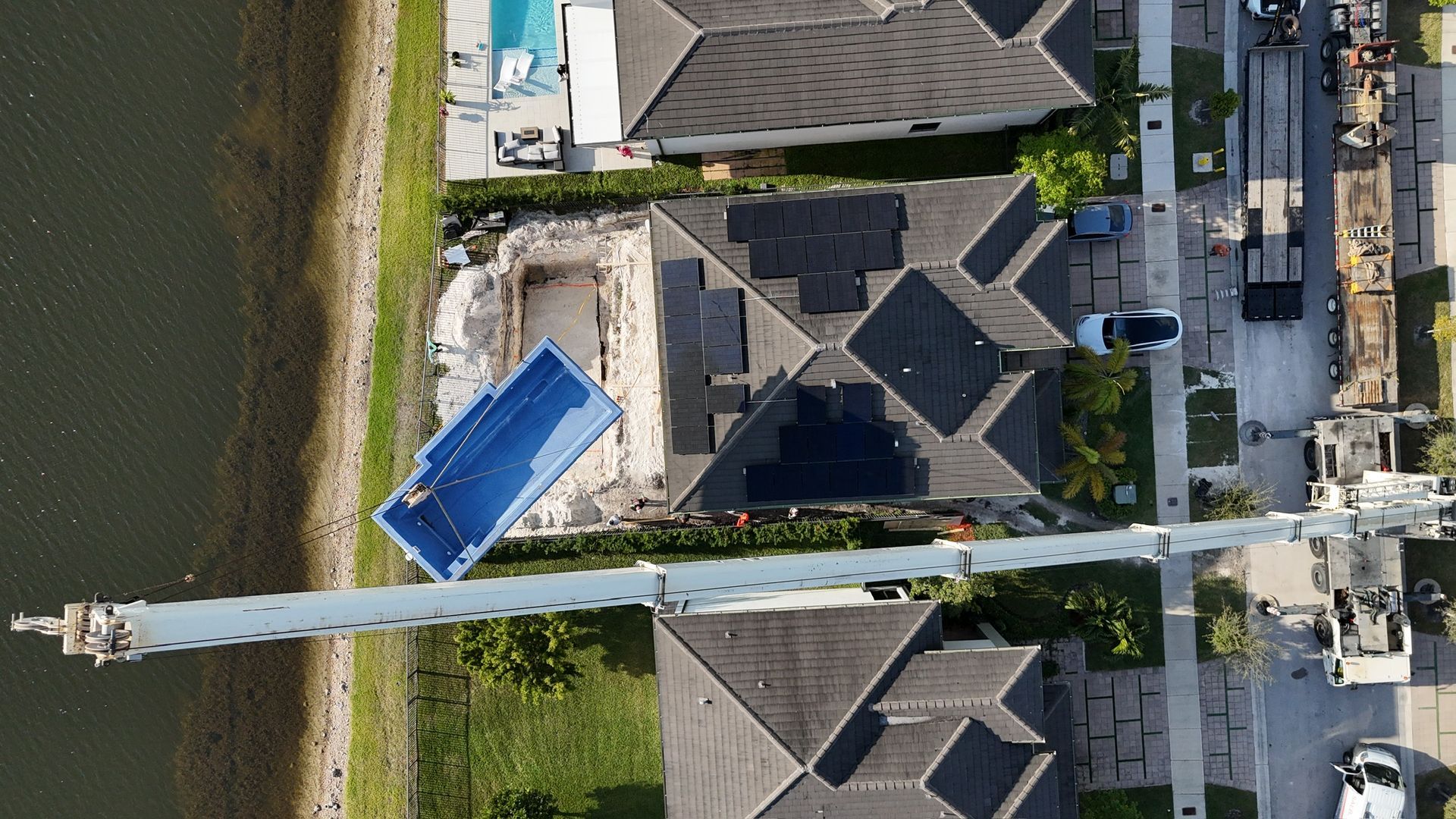 An aerial view of a residential area with a swimming pool in the middle.