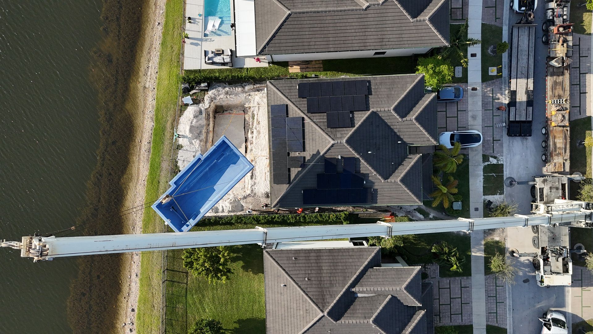 An aerial view of a swimming pool being built in a residential area.