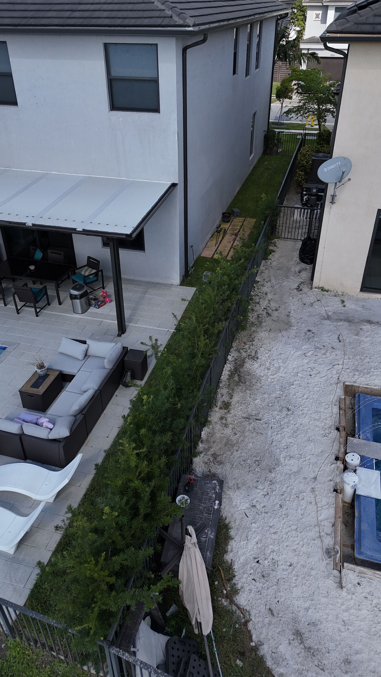 An aerial view of a house with a patio and a pool.