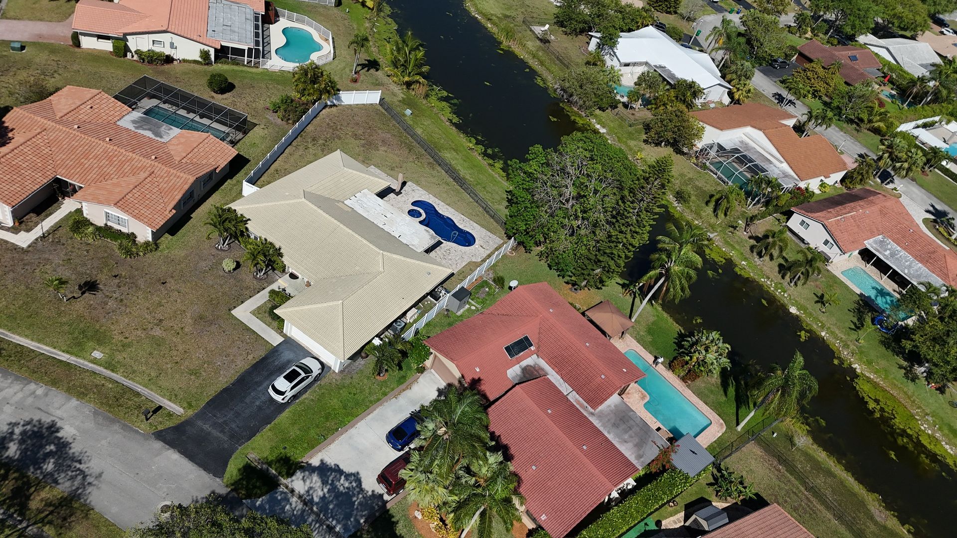 An aerial view of a residential area with lots of houses and a river.
