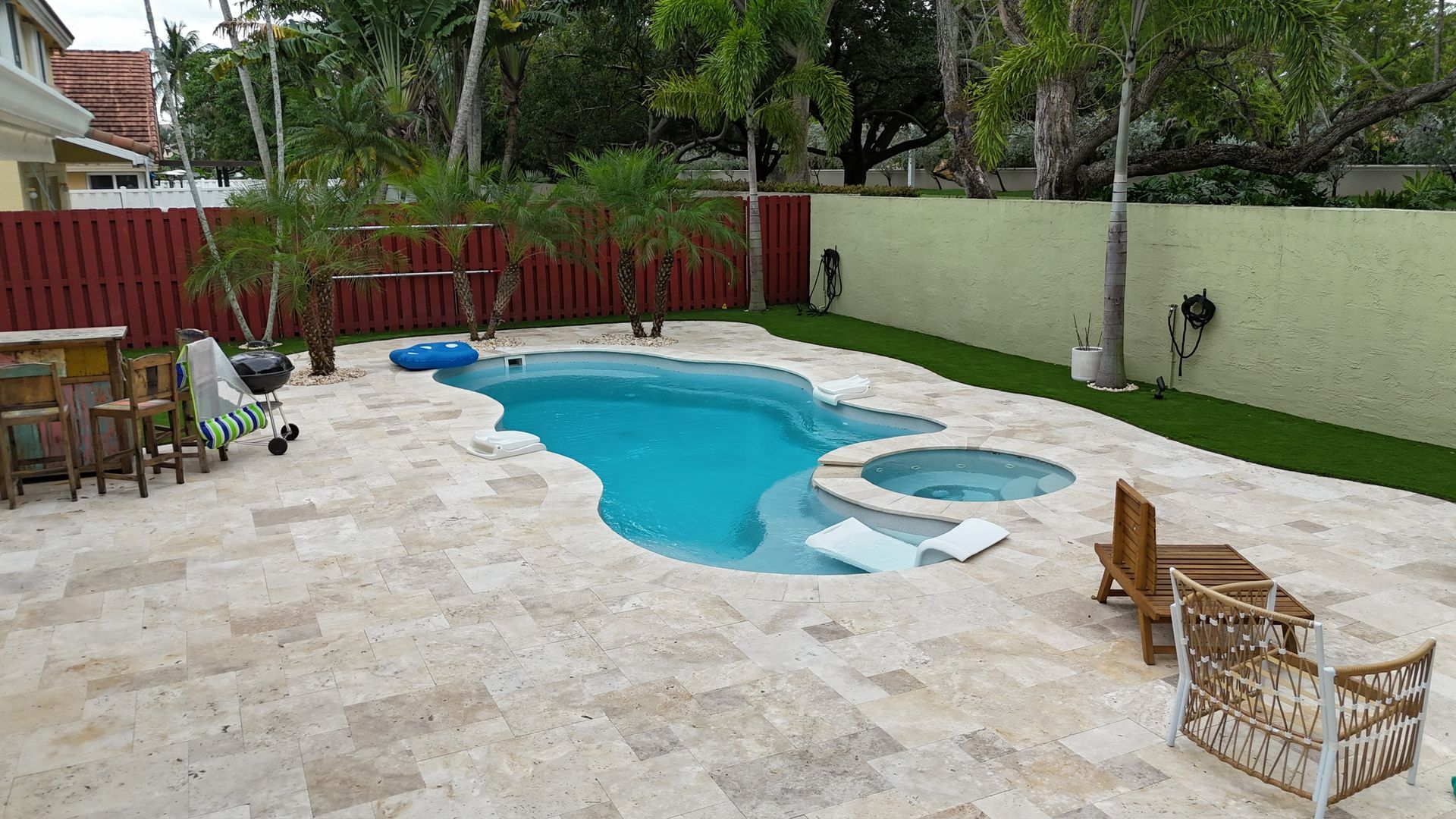 A backyard with a swimming pool and patio furniture