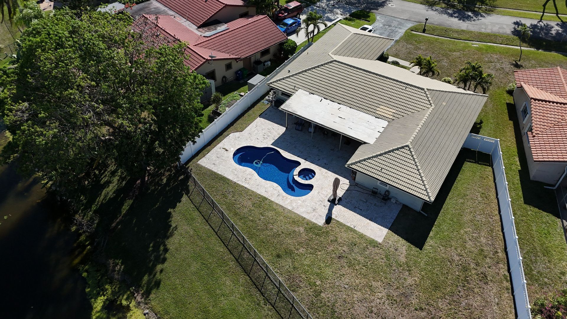An aerial view of a house with a pool in the backyard