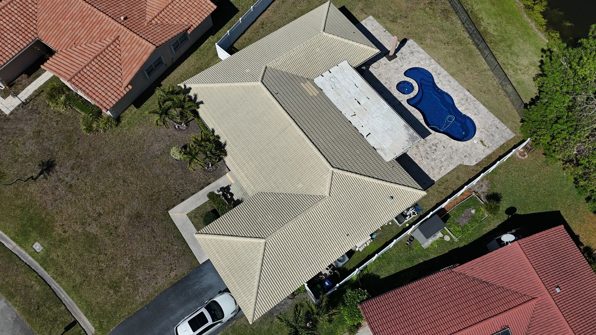An aerial view of a house with a pool in the backyard.