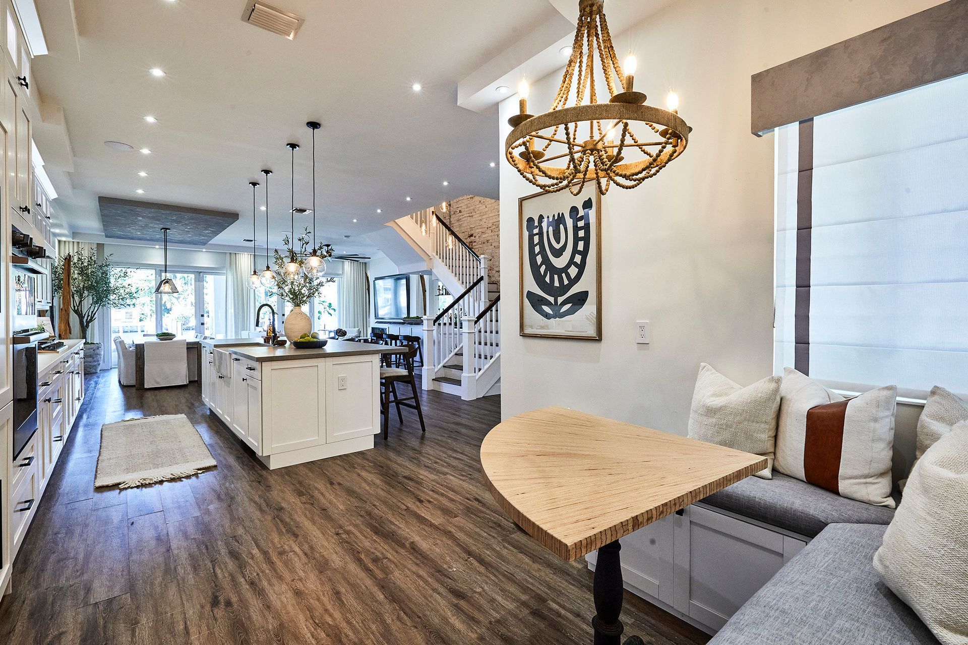 A kitchen with a table and a chandelier hanging from the ceiling.