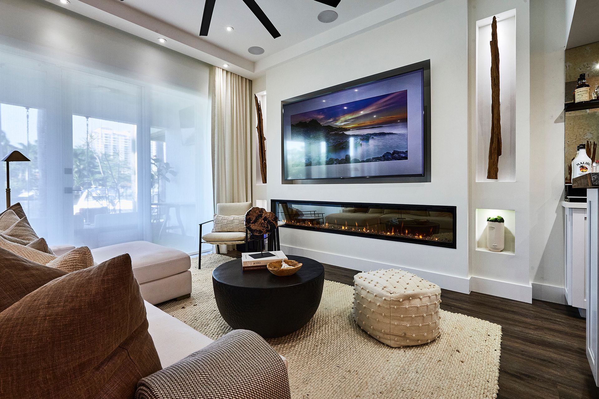 A living room with a large flat screen tv on the wall
