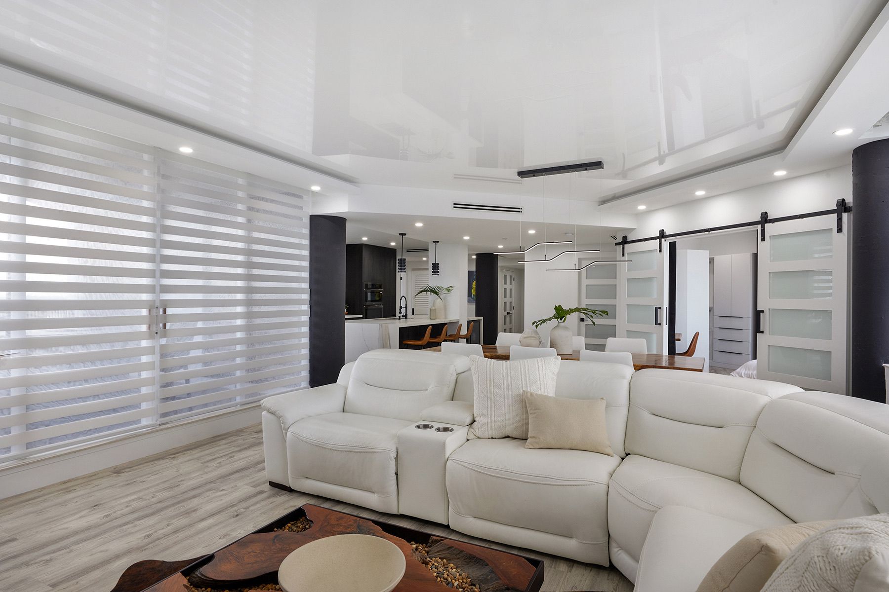 A living room with a white couch and a white ceiling.