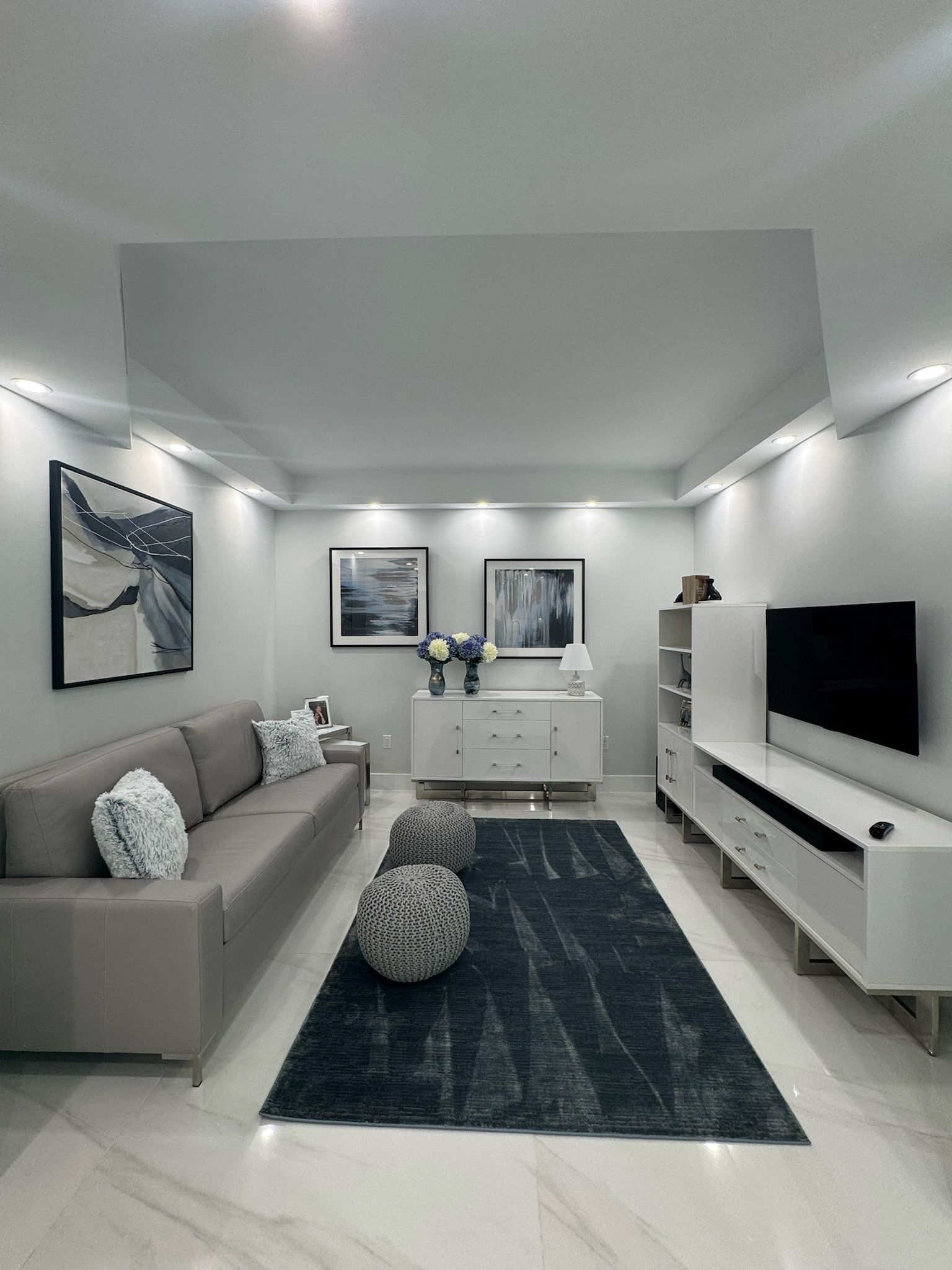 A living room with a couch , rug and television.