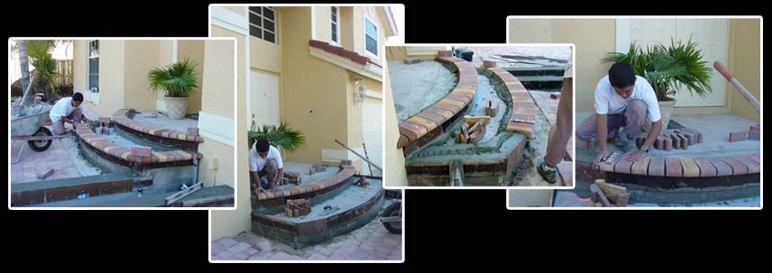 A man is laying bricks on a patio in front of a house