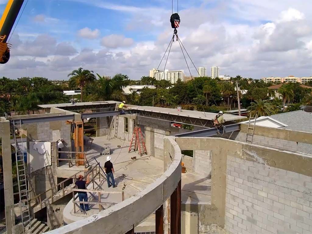A construction site with a crane lifting a beam