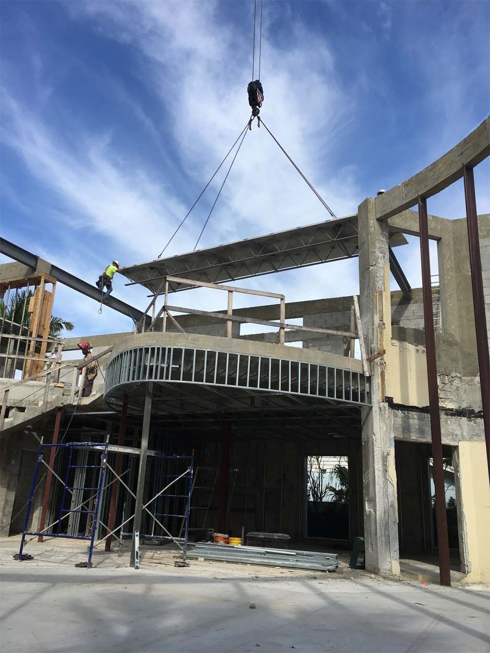 A crane is lifting a concrete structure into place
