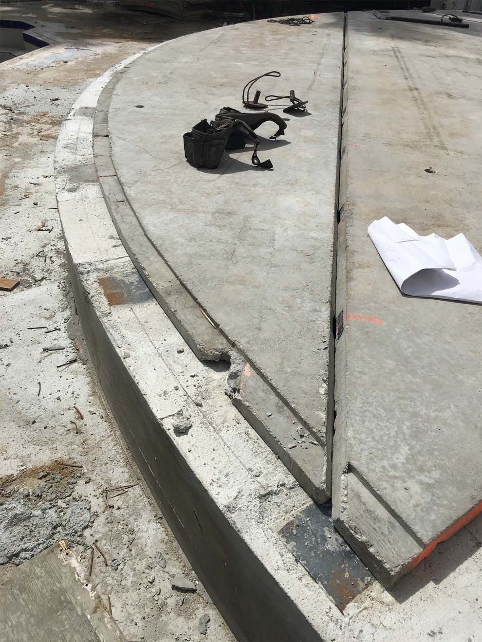 A piece of paper is laying on the ground next to a concrete curb.