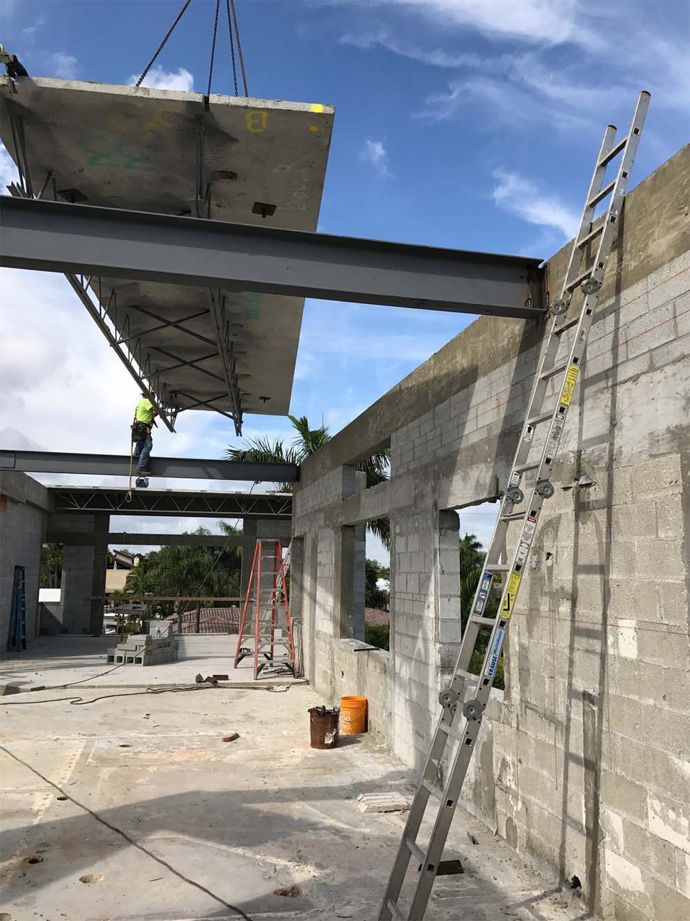 A construction site with a ladder and a crane in the background